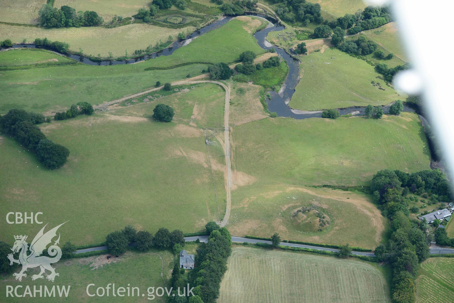 Aerial photograph: Tomen Llanio motte, with parchmarks. Crown: CHERISH PROJECT 2018. Produced with EU funds through the Ireland Wales Co-operation Programme 2014-2020 (NGR SN660579)