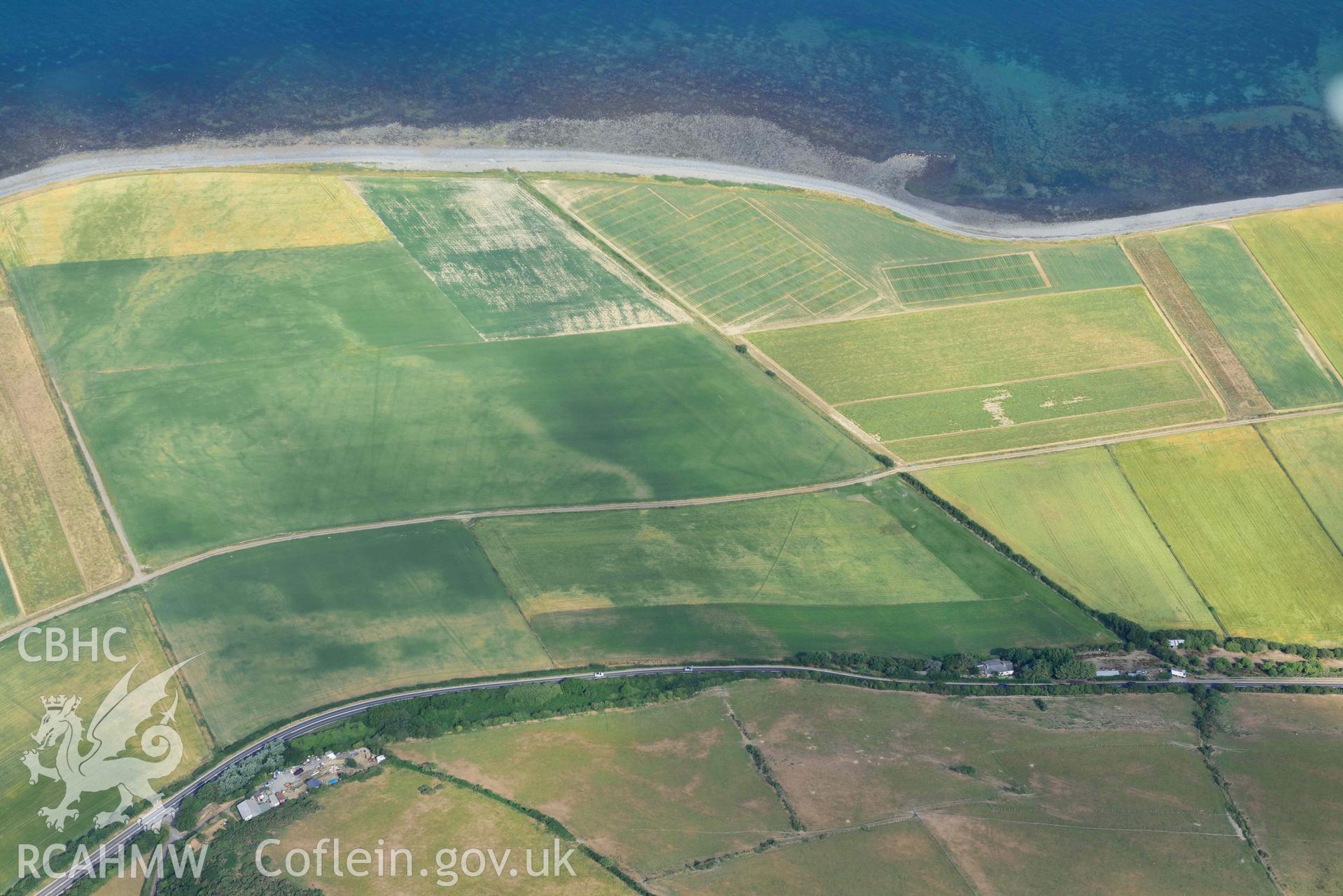 Aerial photograph: Llanon defended enclosure, Morfa Mawr. Crown: CHERISH PROJECT 2018. Produced with EU funds through the Ireland Wales Co-operation Programme 2014-2020 (NGR: SN505662)