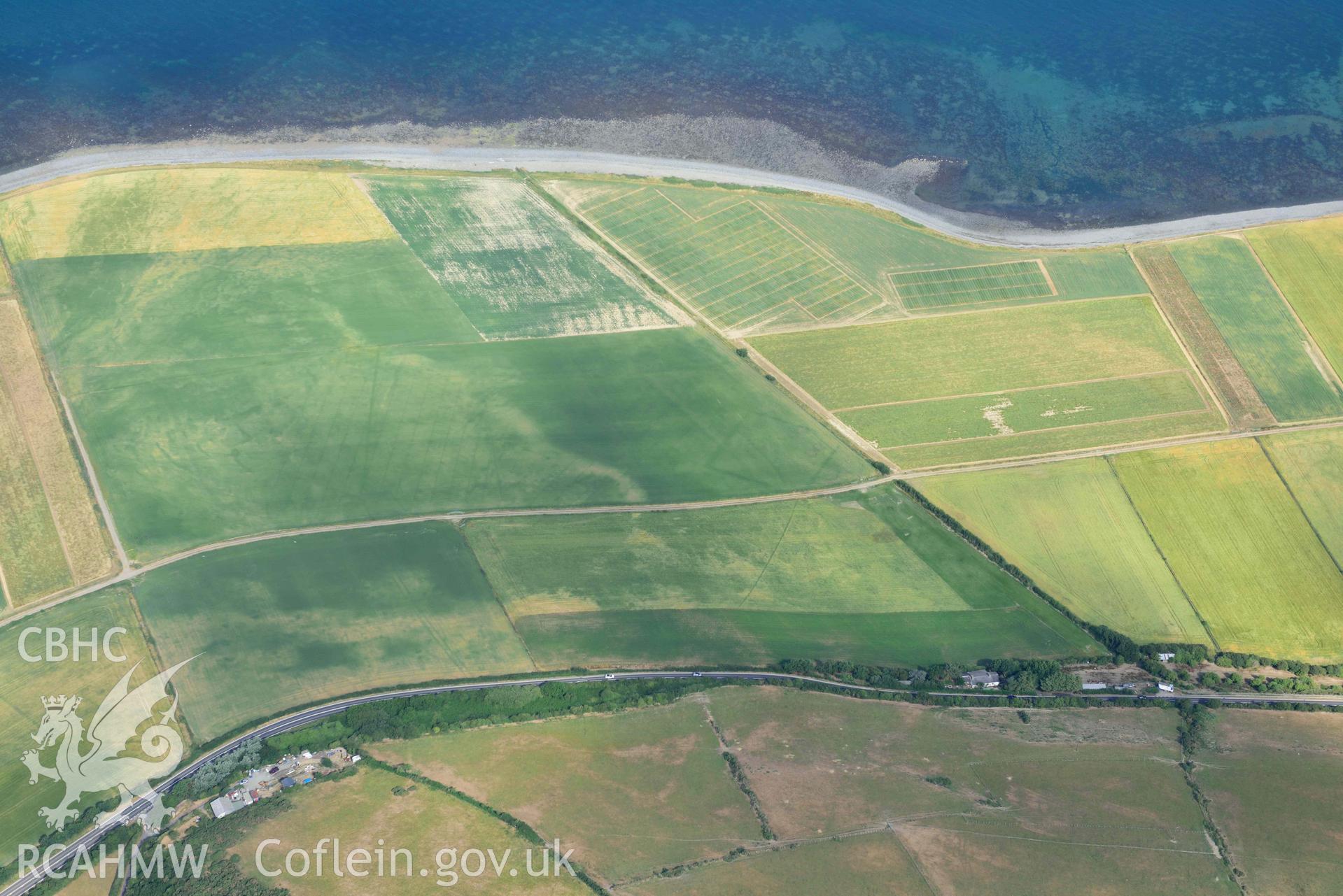 Aerial photograph: Llanon defended enclosure, Morfa Mawr. Crown: CHERISH PROJECT 2018. Produced with EU funds through the Ireland Wales Co-operation Programme 2014-2020 (NGR: SN505662)