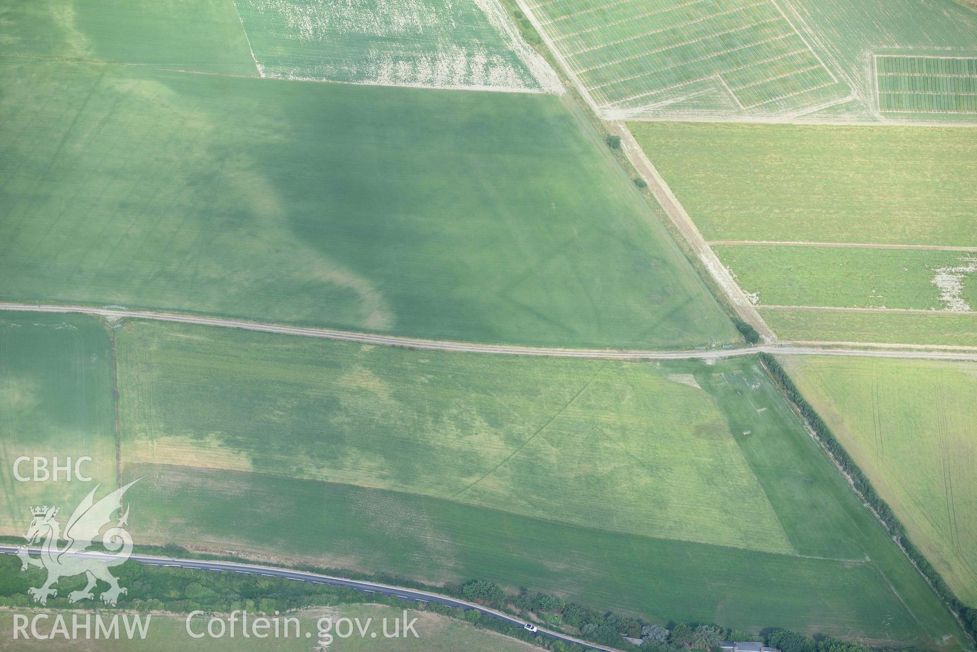 Aerial photograph: Llanon defended enclosure, Morfa Mawr. Crown: CHERISH PROJECT 2018. Produced with EU funds through the Ireland Wales Co-operation Programme 2014-2020 (NGR: SN505662)