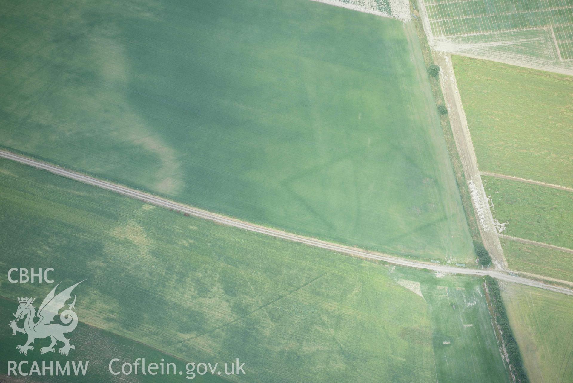 Aerial photograph: Llanon defended enclosure, Morfa Mawr. Crown: CHERISH PROJECT 2018. Produced with EU funds through the Ireland Wales Co-operation Programme 2014-2020 (NGR: SN505662)