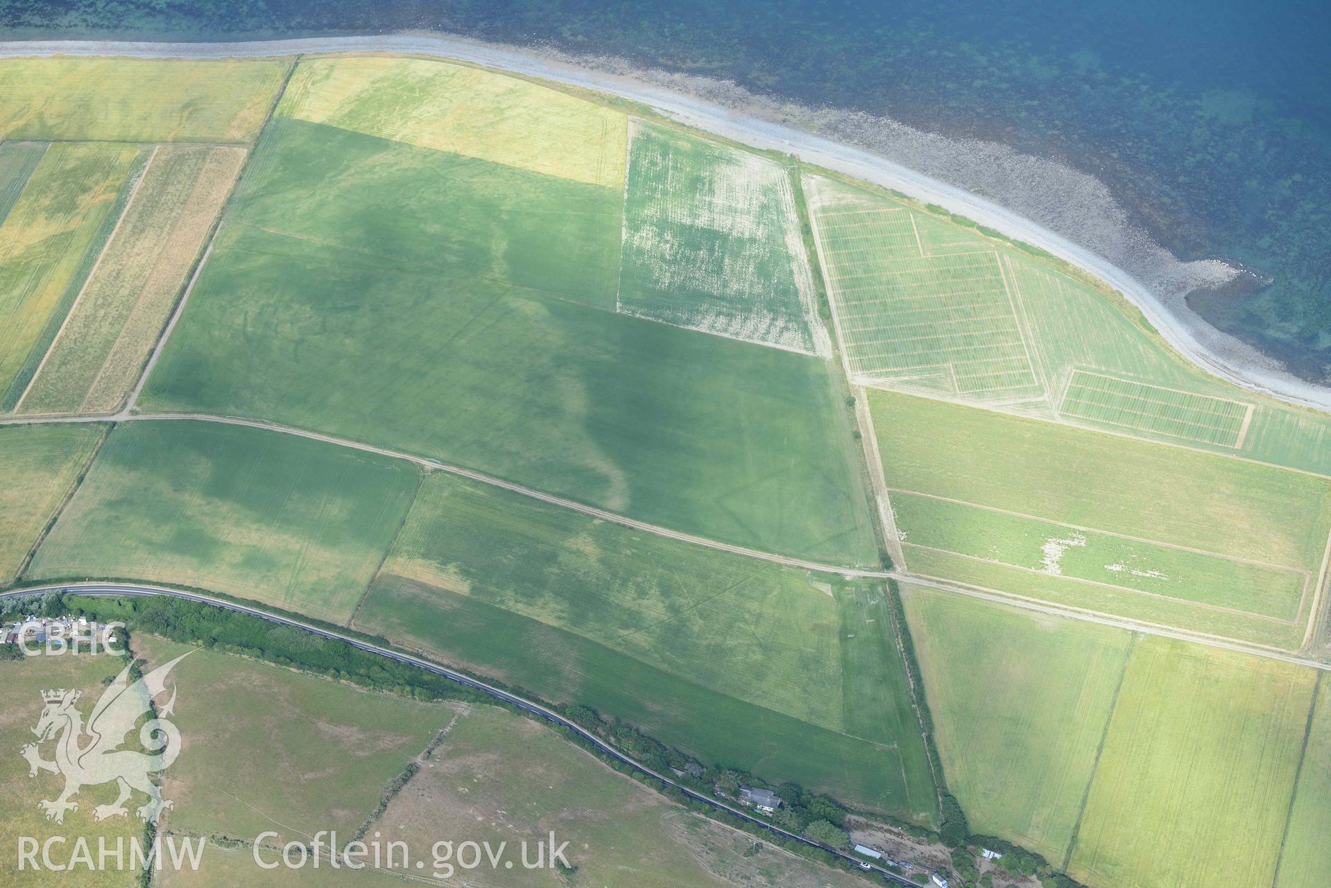 Aerial photograph: Llanon defended enclosure, Morfa Mawr. Crown: CHERISH PROJECT 2018. Produced with EU funds through the Ireland Wales Co-operation Programme 2014-2020 (NGR: SN505662)