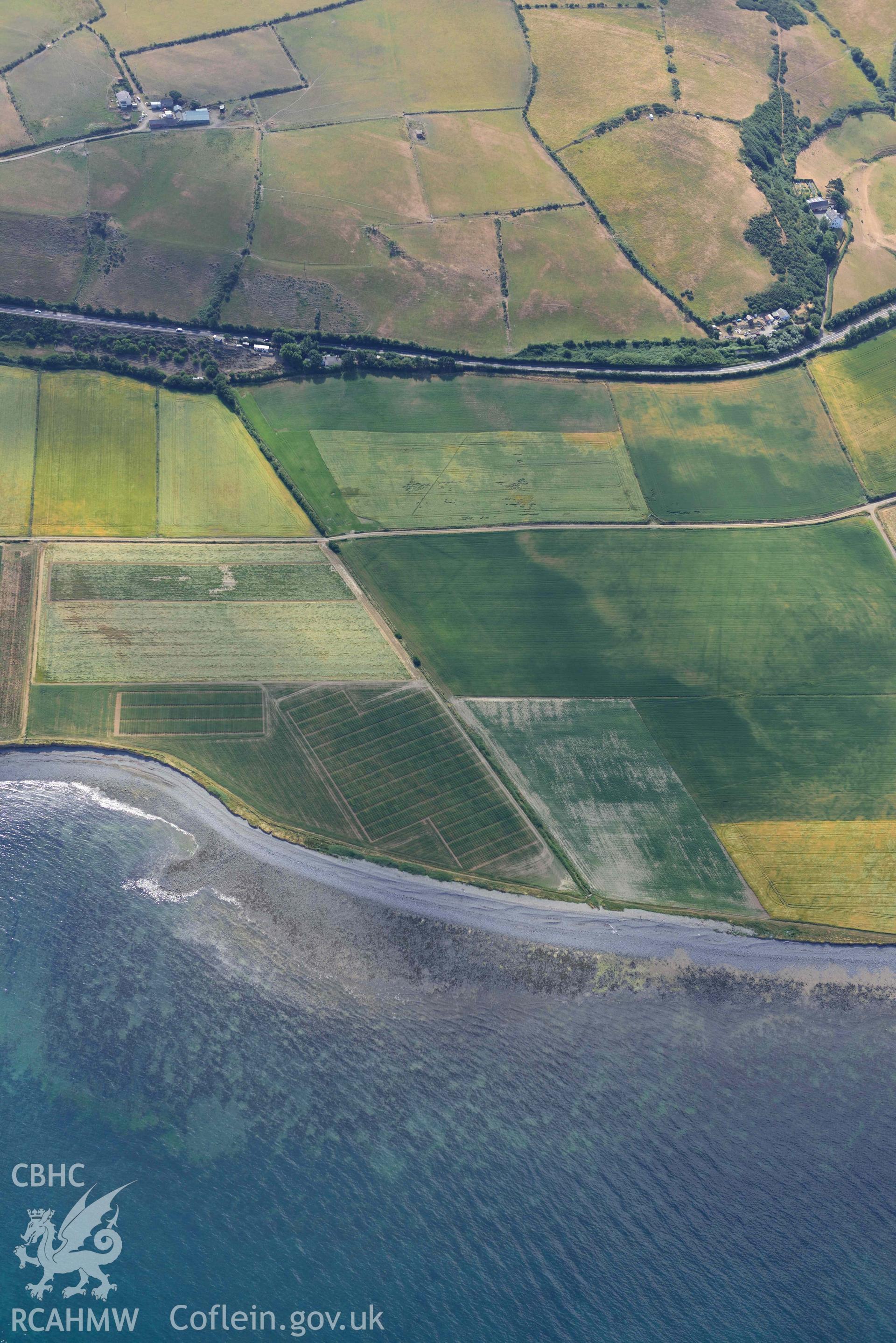 Aerial photograph: Llanon defended enclosure, Morfa Mawr. Crown: CHERISH PROJECT 2018. Produced with EU funds through the Ireland Wales Co-operation Programme 2014-2020 (NGR: SN505662)