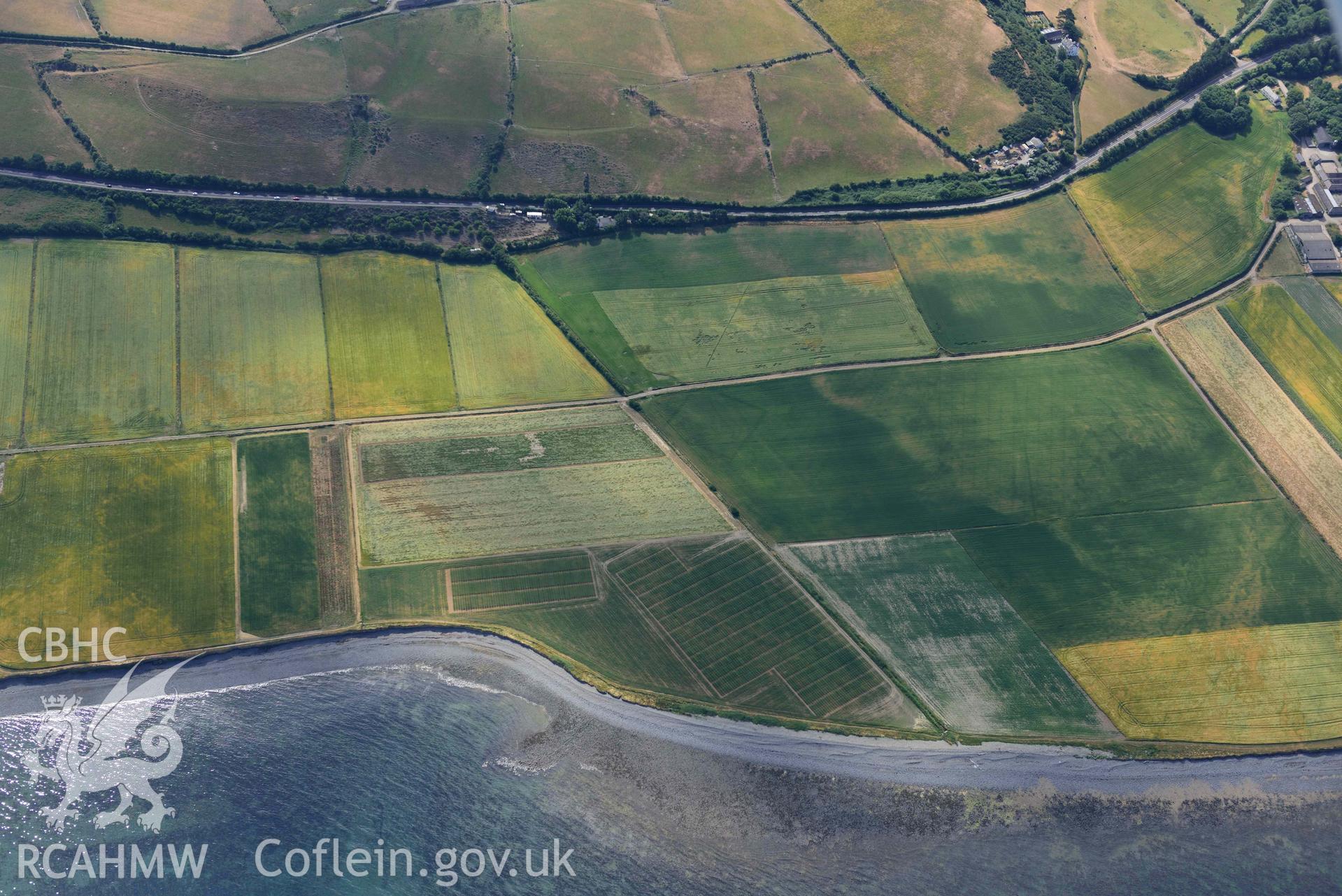 Aerial photograph: Llanon defended enclosure, Morfa Mawr. Crown: CHERISH PROJECT 2018. Produced with EU funds through the Ireland Wales Co-operation Programme 2014-2020 (NGR: SN505662)