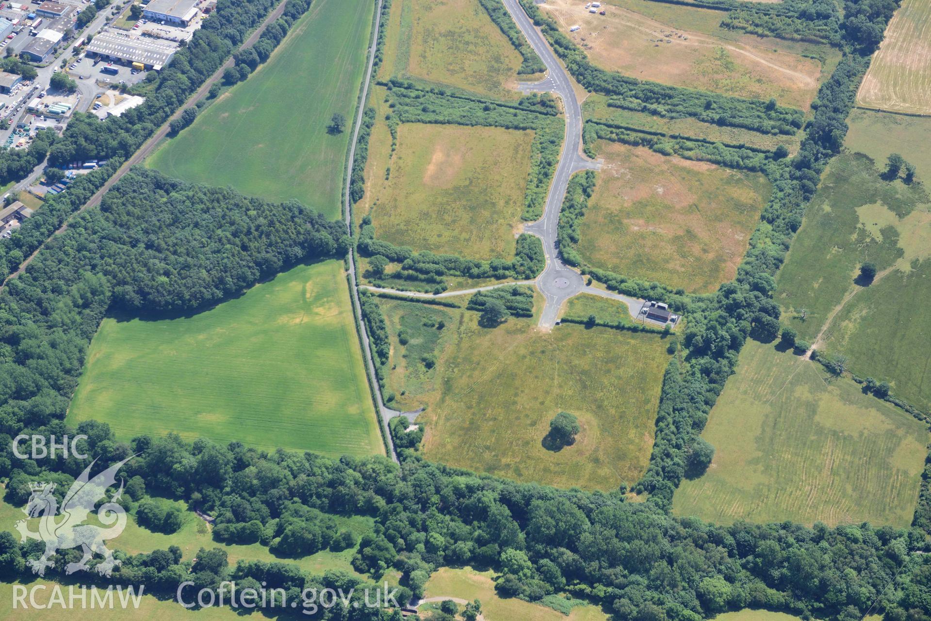 Aerial photograph: Parc Bryn Cegin oval cropmark enclosure. Wide view looking south-west. Crown: CHERISH PROJECT 2018. Produced with EU funds through the Ireland Wales Co-operation Programme 2014-2020 (NGR: SH588707)