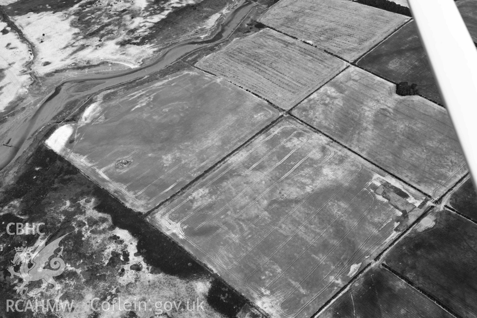 Aerial photograph: Cropmarks at Rhuddgaer. Crown: CHERISH PROJECT 2018. Produced with EU funds through the Ireland Wales Co-operation Programme 2014-2020 (NGR: SH441638)