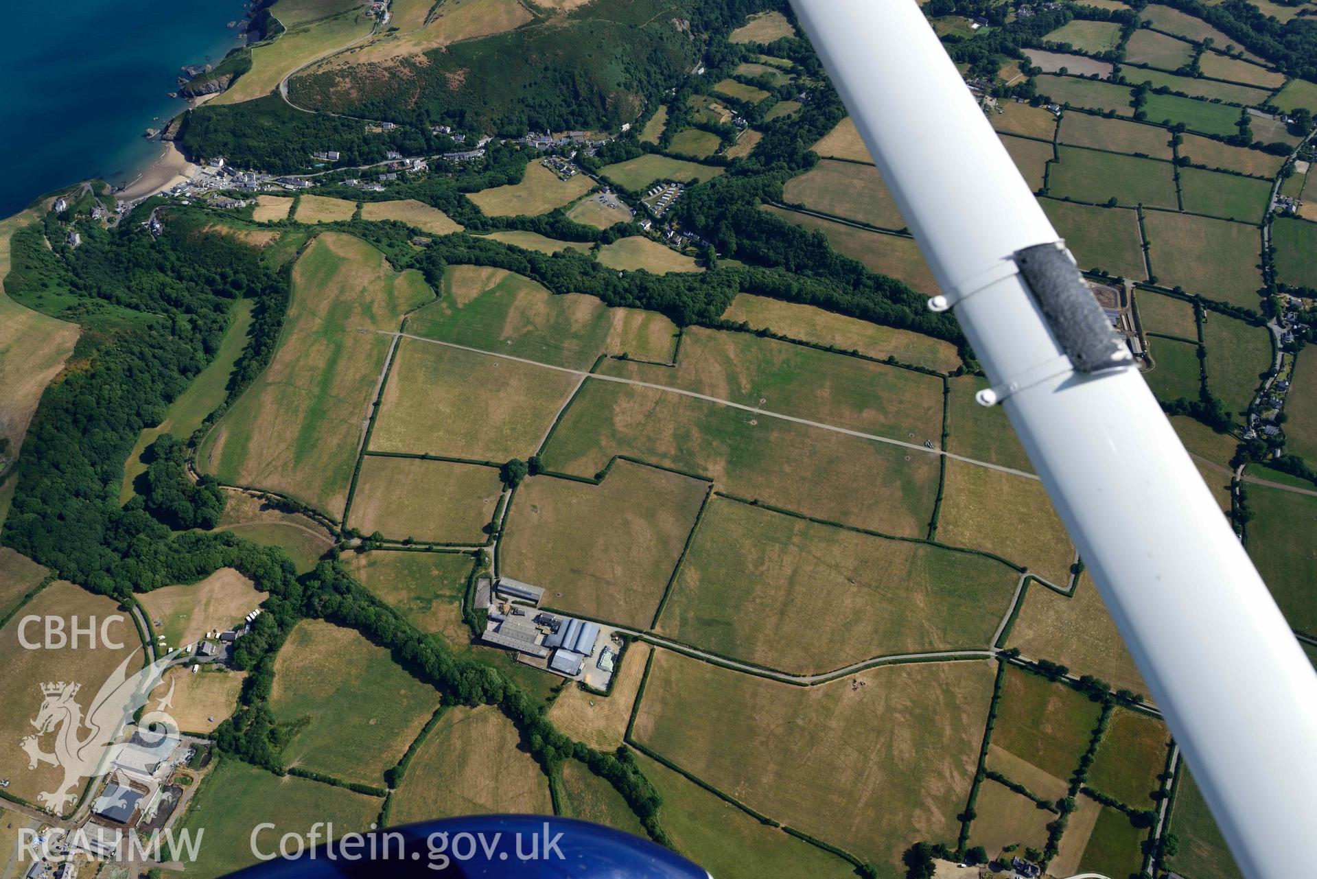 Aerial photograph: Eisteddfa circular enclosure cropmarks, wide landscape view showing context. Crown: CHERISH PROJECT 2018. Produced with EU funds through the Ireland Wales Co-operation Programme 2014-2020 (NGR: SN314529)