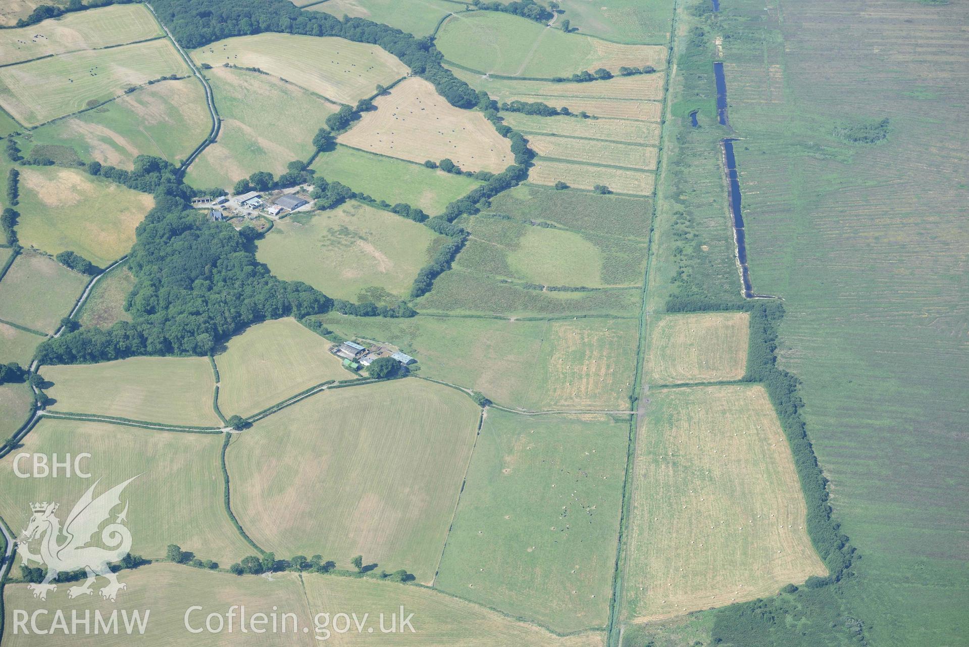 Aerial photograph: Ynyscapel defended enclosure cropmark, wide landscape view from east. Crown: CHERISH PROJECT 2018. Produced with EU funds through the Ireland Wales Co-operation Programme 2014-2020 (NGR: SN643905)