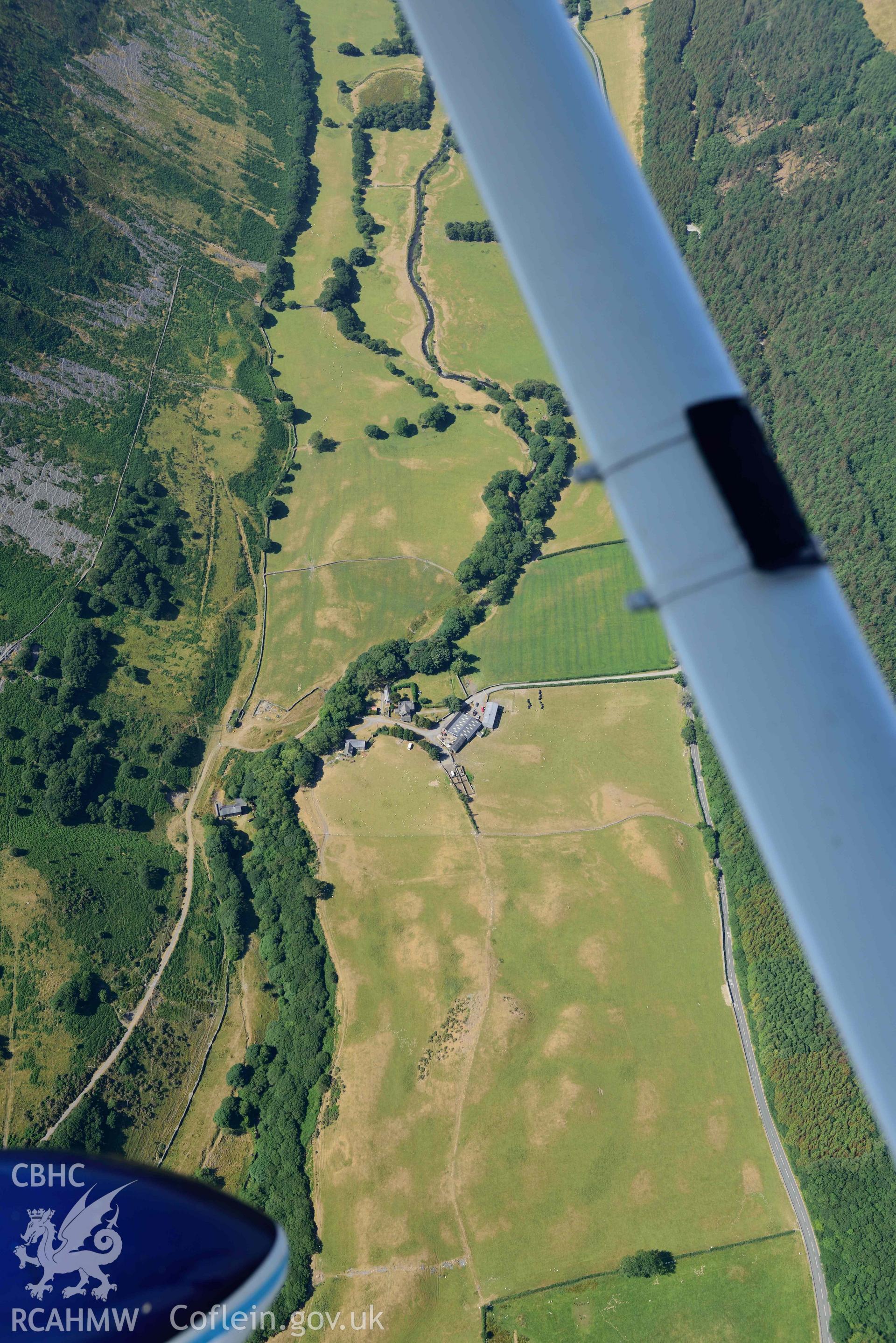 Aerial photograph: Maes y Pandy, cropmarks of quarry pits and trackways. Crown: CHERISH PROJECT 2018. Produced with EU funds through the Ireland Wales Co-operation Programme 2014-2020 (NGR: SH703087)