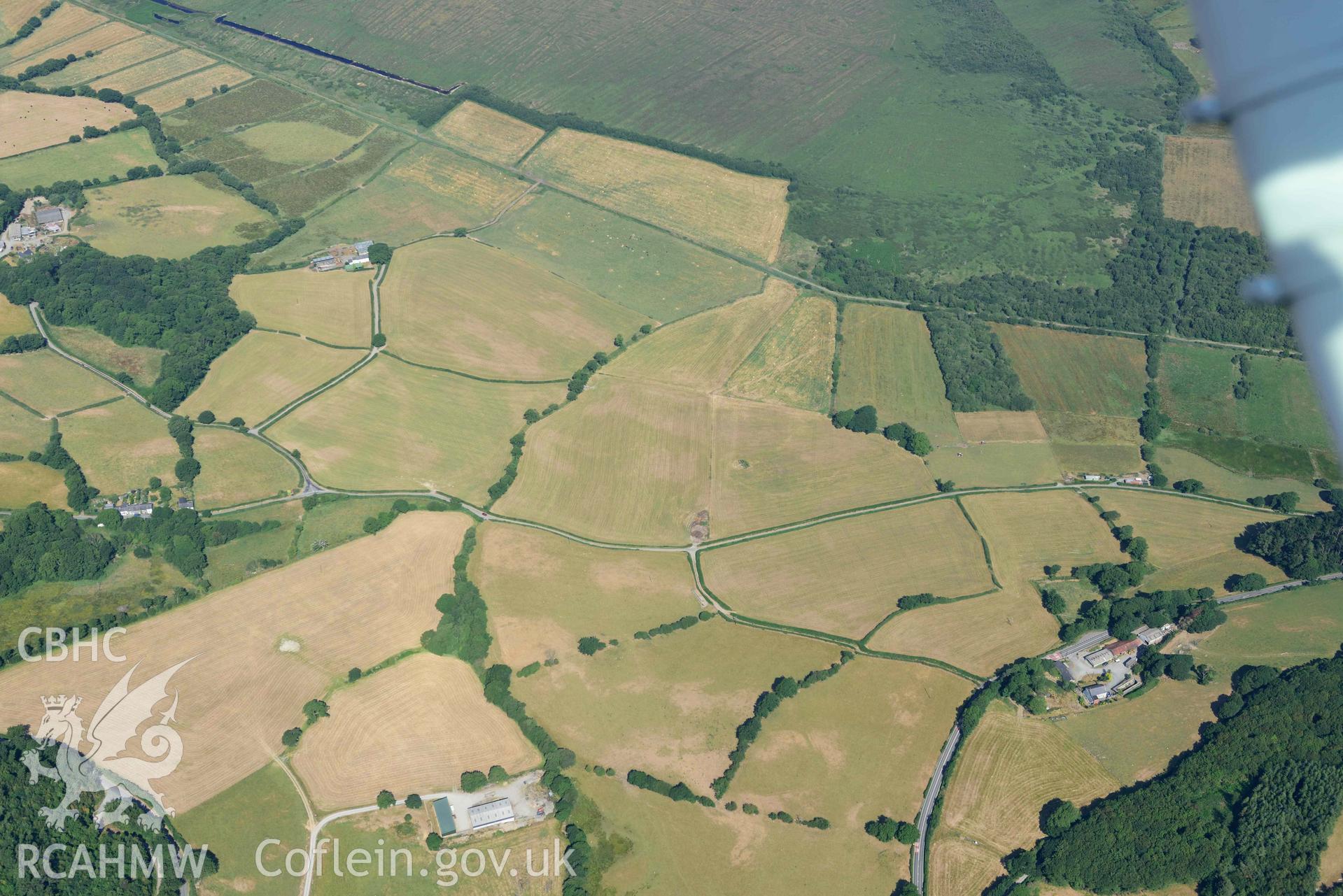 Aerial photograph: Erglodd Roman fortlet, cropmark. Wide view from southeast with surrounding parchmarks. Crown: CHERISH PROJECT 2018. Produced with EU funds through the Ireland Wales Co-operation Programme 2014-2020 (NGR: SN652903)