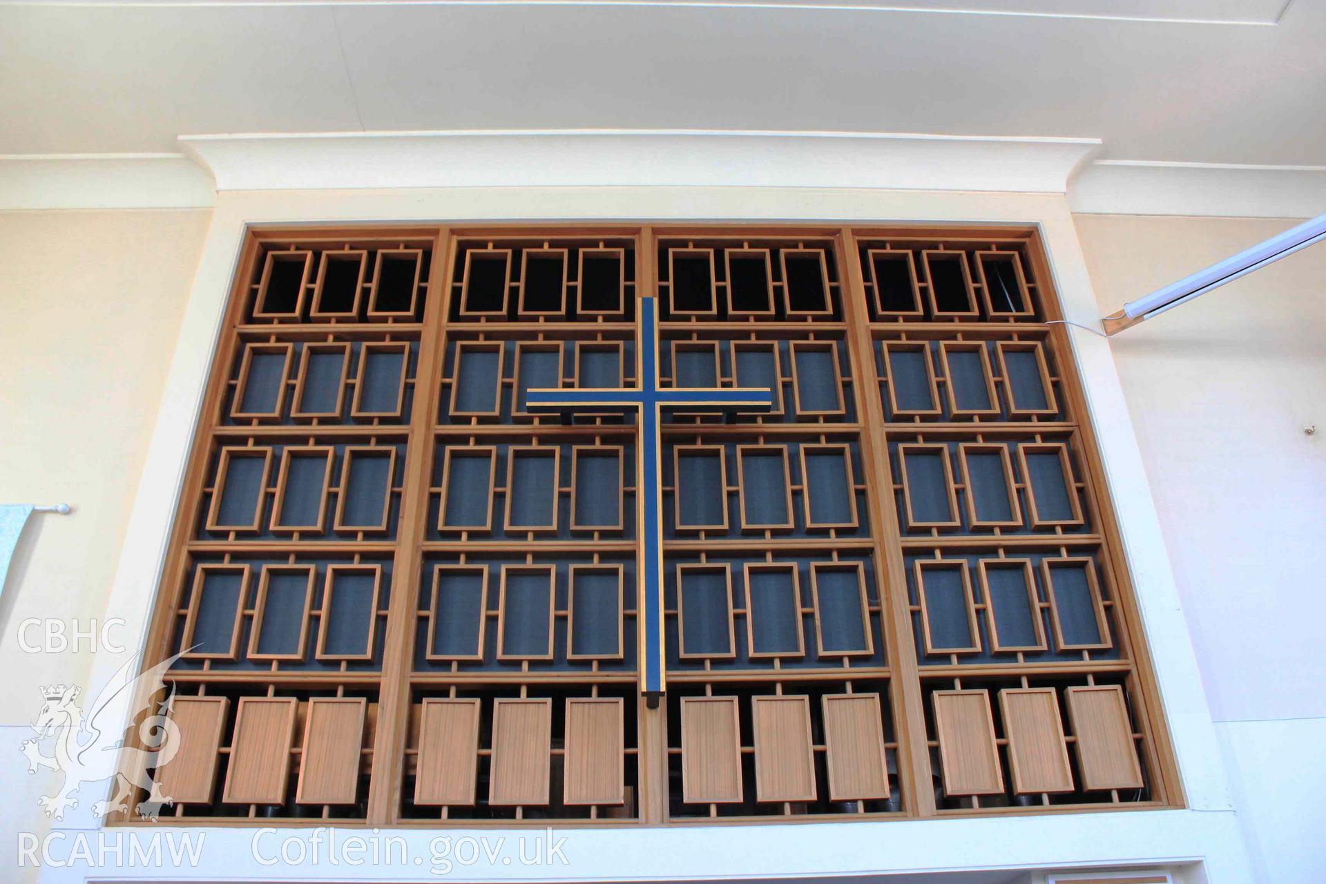 Cross and wooden detail before organ pipes