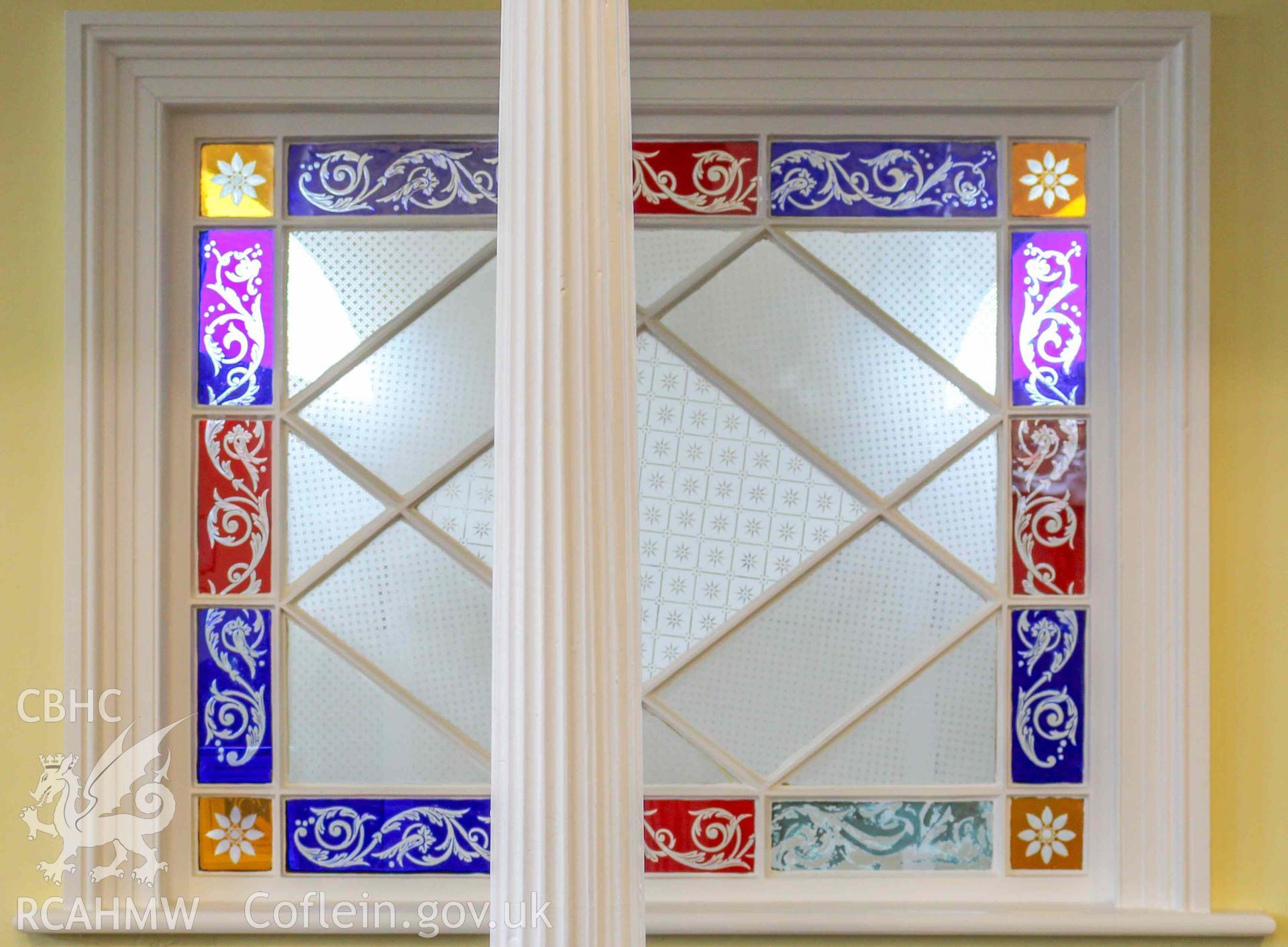 Hen Gapel - View of the stained-glass window between the foyer and nave, partly concealed by a pillar, taken from North-West