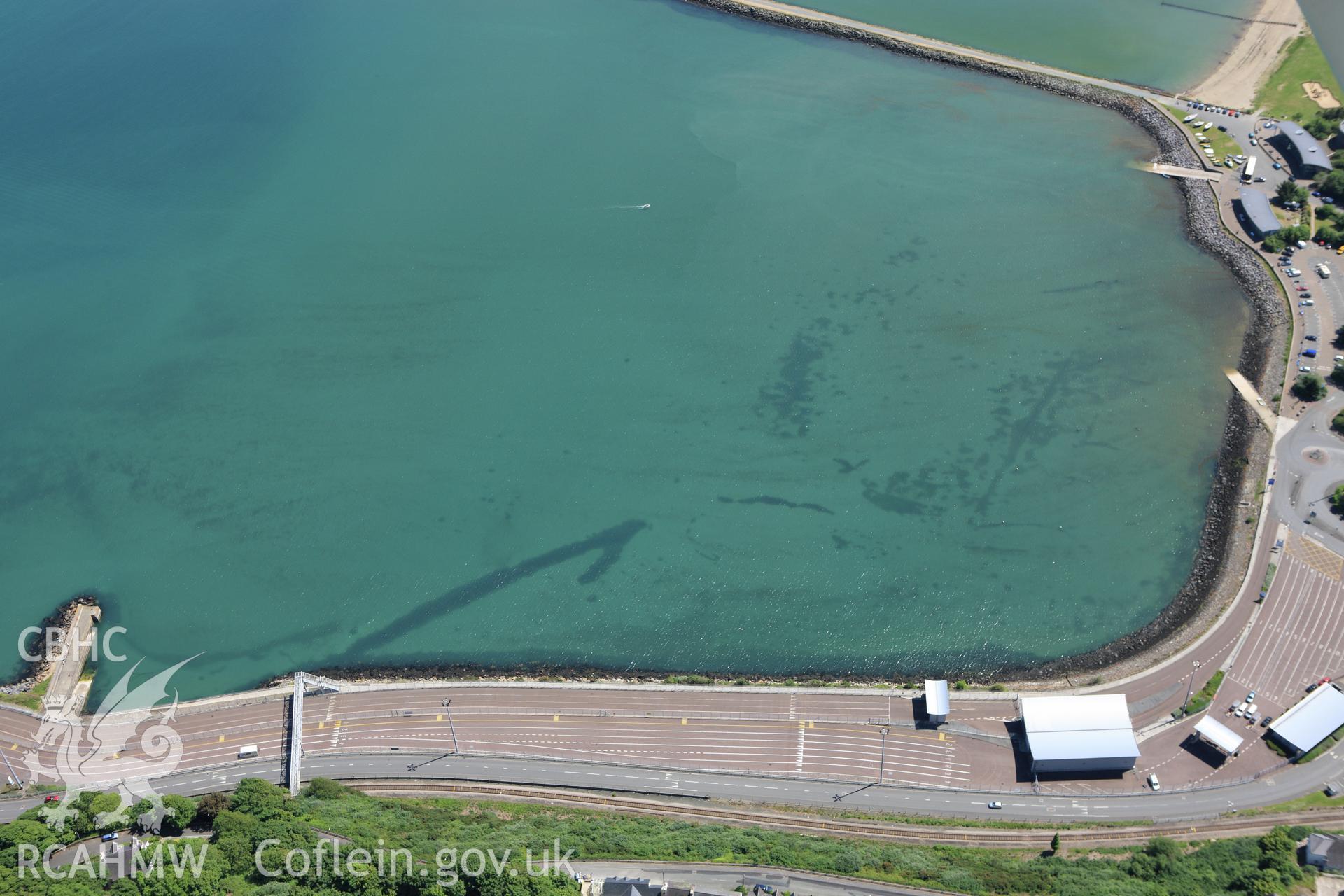 RCAHMW colour oblique aerial photograph of Fishguard Harbour North-West Fish Trap. Taken on 01 June 2009 by Toby Driver