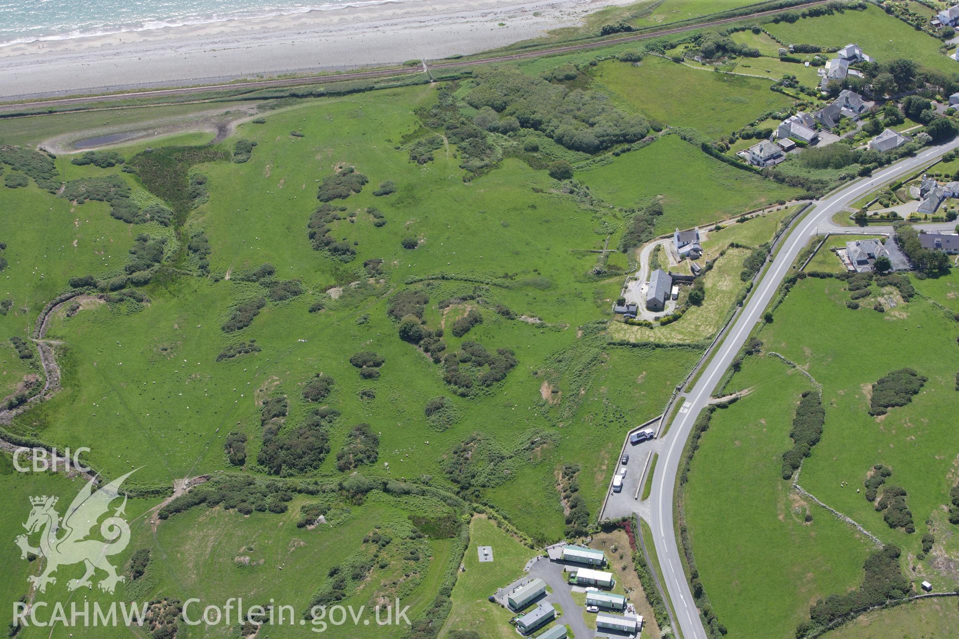 RCAHMW colour oblique aerial photograph of Caer-Dynni Burial Chamber. Taken on 16 June 2009 by Toby Driver