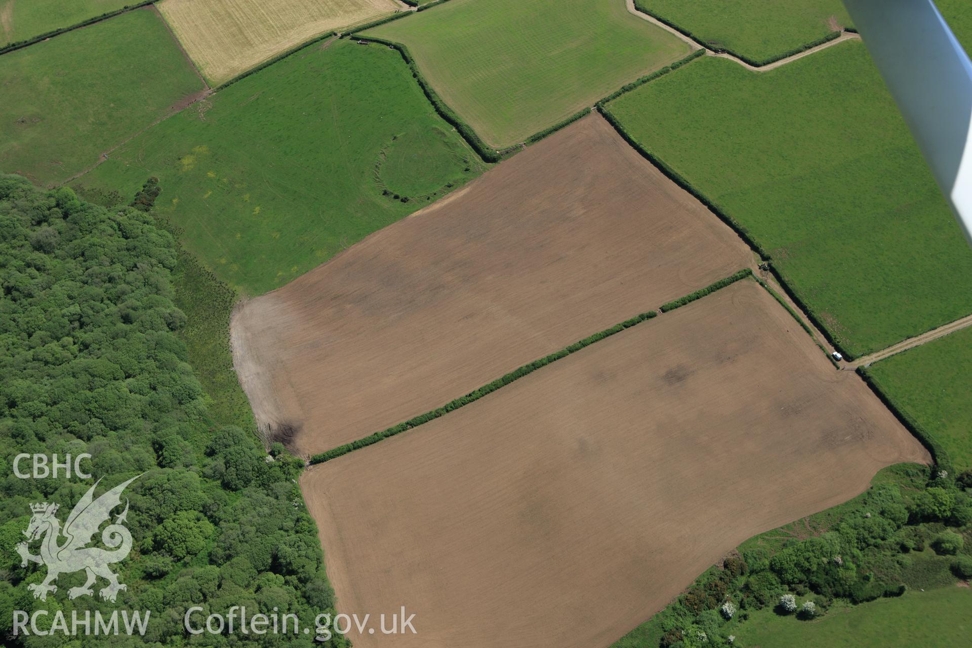 RCAHMW colour oblique aerial photograph of Ford Camp showing ploughing. Taken on 01 June 2009 by Toby Driver