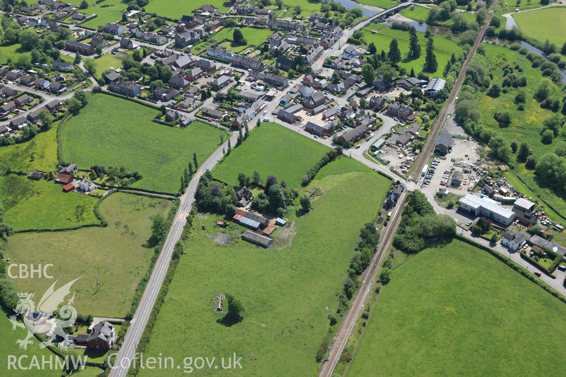 RCAHMW colour oblique aerial photograph of Caersws Roman Military Settlement. Taken on 02 June 2009 by Toby Driver