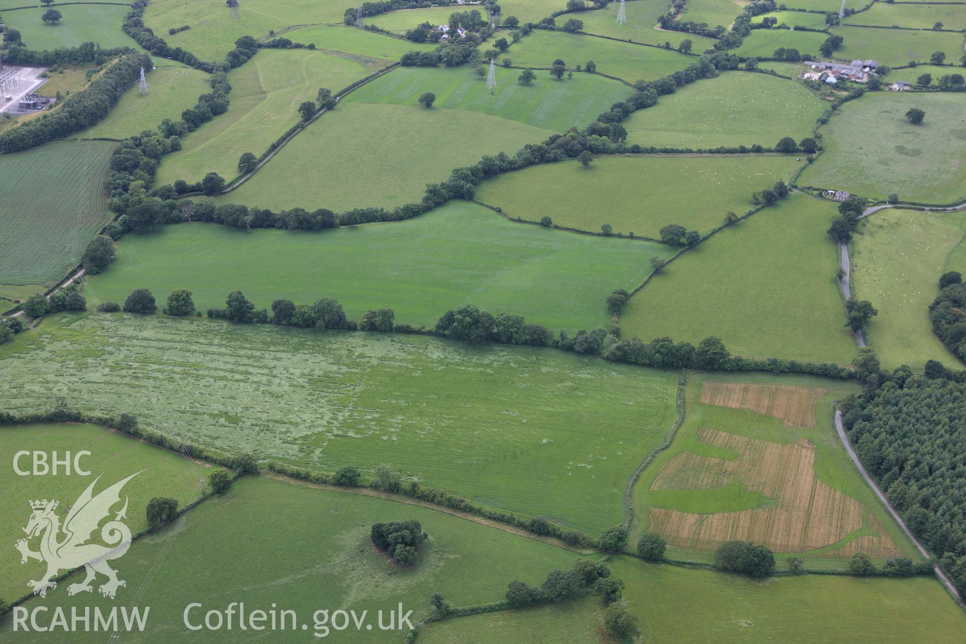 RCAHMW colour oblique aerial photograph of a section of Offa's Dyke at Cadwgan Hall extending from the River Clywedog to the railway. Taken on 08 July 2009 by Toby Driver