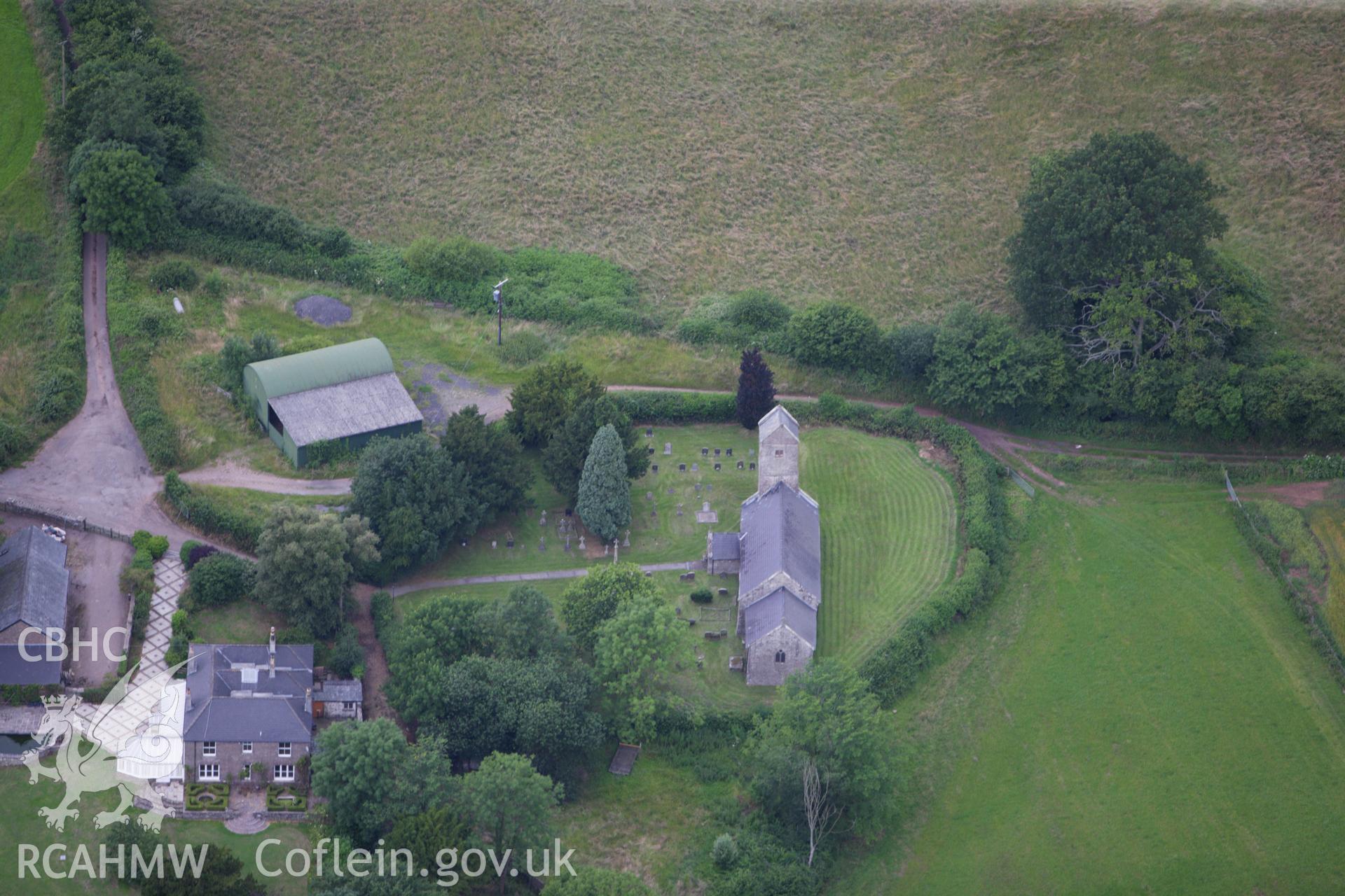 RCAHMW colour oblique aerial photograph of St Thomas a Becket, Wolvesnewton, showing the churchyard cross. Taken on 09 July 2009 by Toby Driver