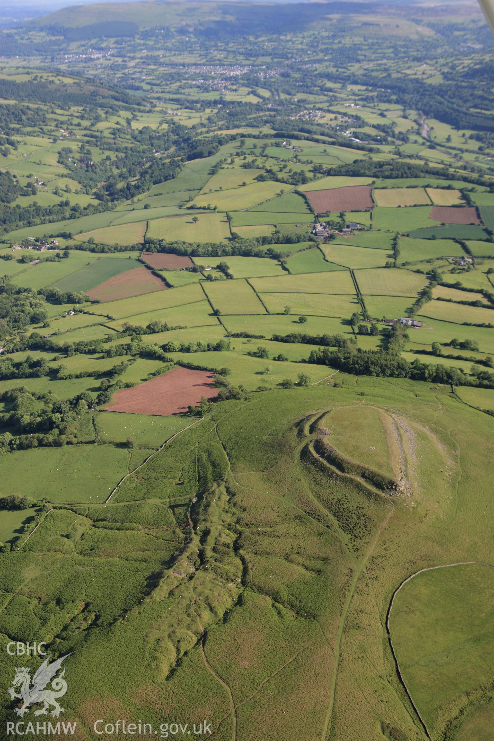 RCAHMW colour oblique aerial photograph of Crug Hywel Camp. Taken on 11 June 2009 by Toby Driver