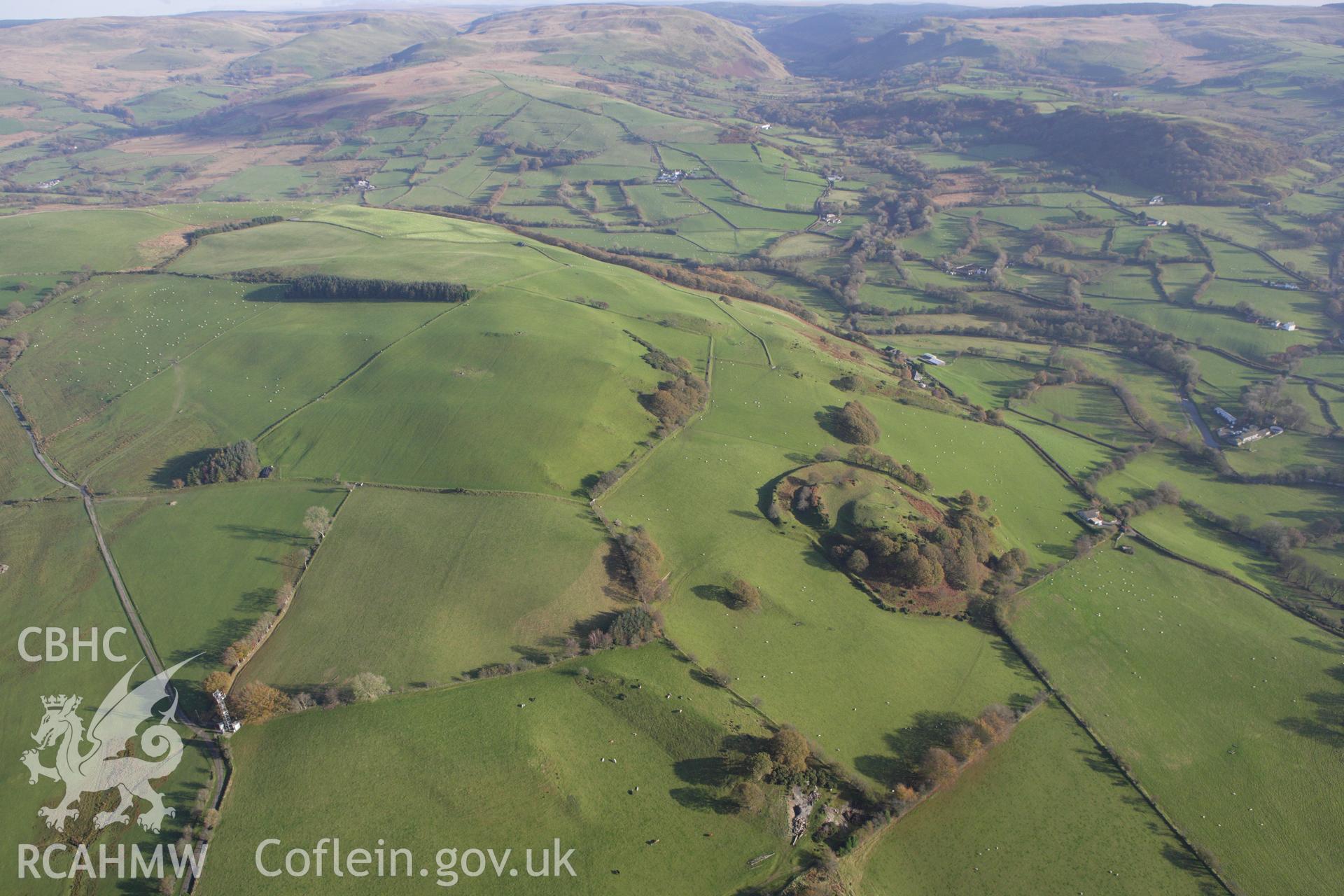 RCAHMW colour oblique aerial photograph of Castell Tregaron (Sunnyhill Wood Camp). Taken on 09 November 2009 by Toby Driver