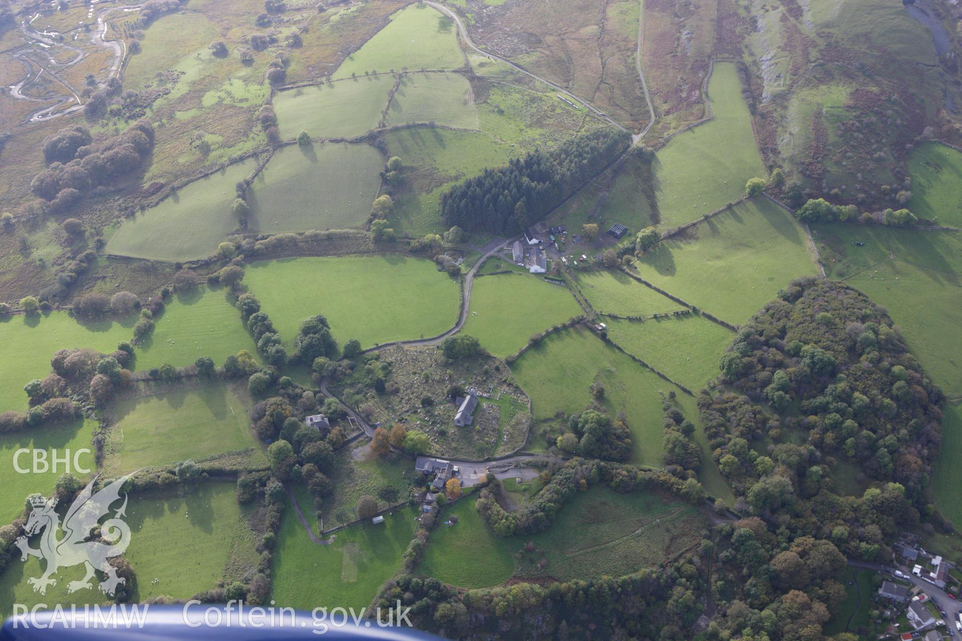 RCAHMW colour oblique aerial photograph of St Cynog's Church. Taken on 14 October 2009 by Toby Driver