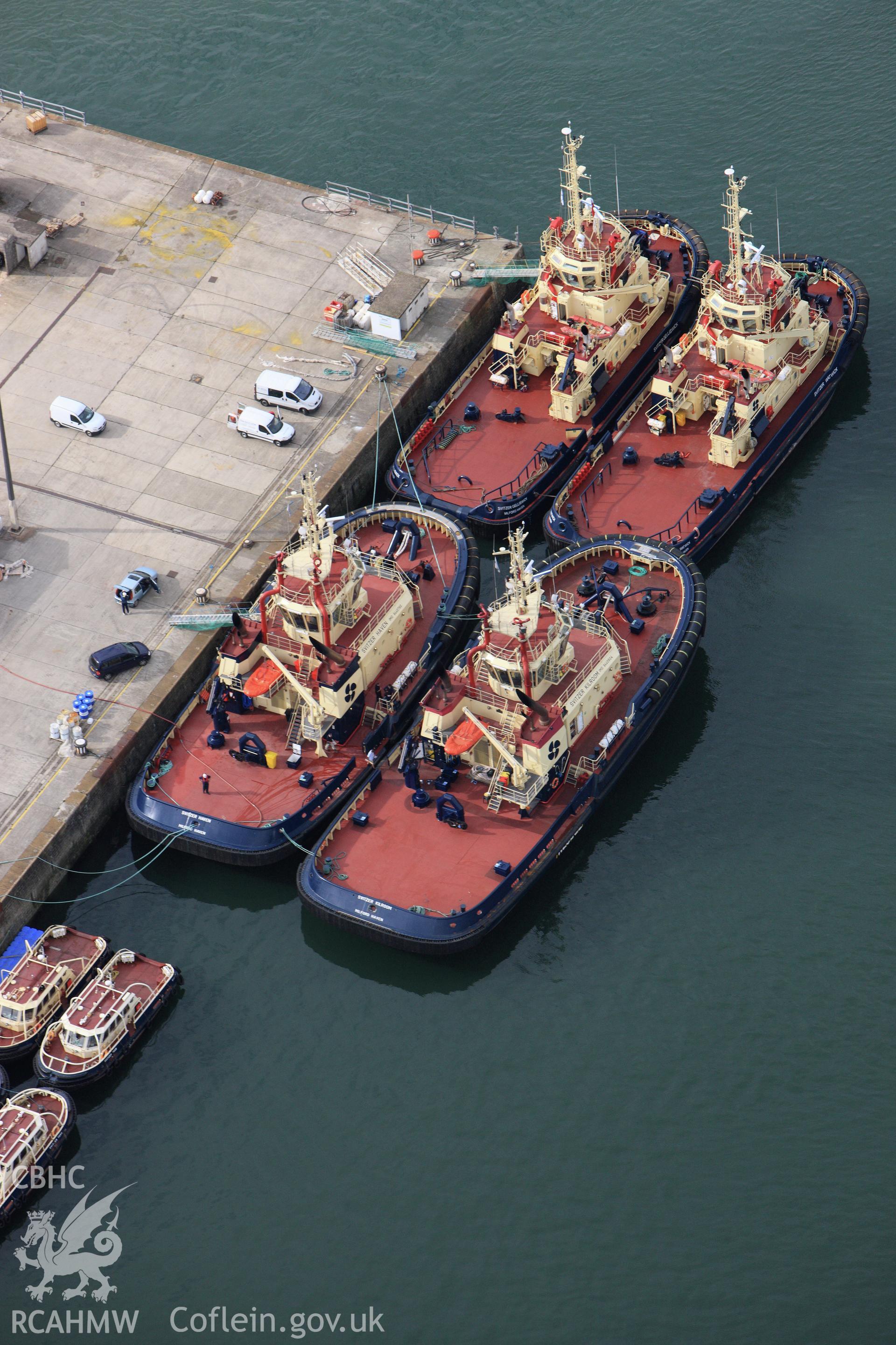 RCAHMW colour oblique aerial photograph of The Royal Dockyard at Pembroke Dock showing Port Authority tugs. Taken on 14 October 2009 by Toby Driver