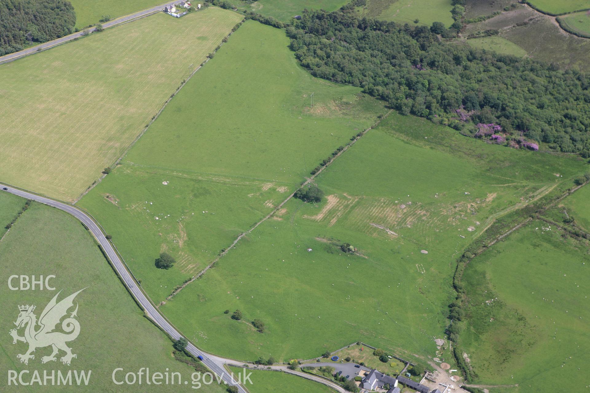 RCAHMW colour oblique aerial photograph of a rectangular earthwork 110m northwest of Coed Ty Mawr. Taken on 16 June 2009 by Toby Driver