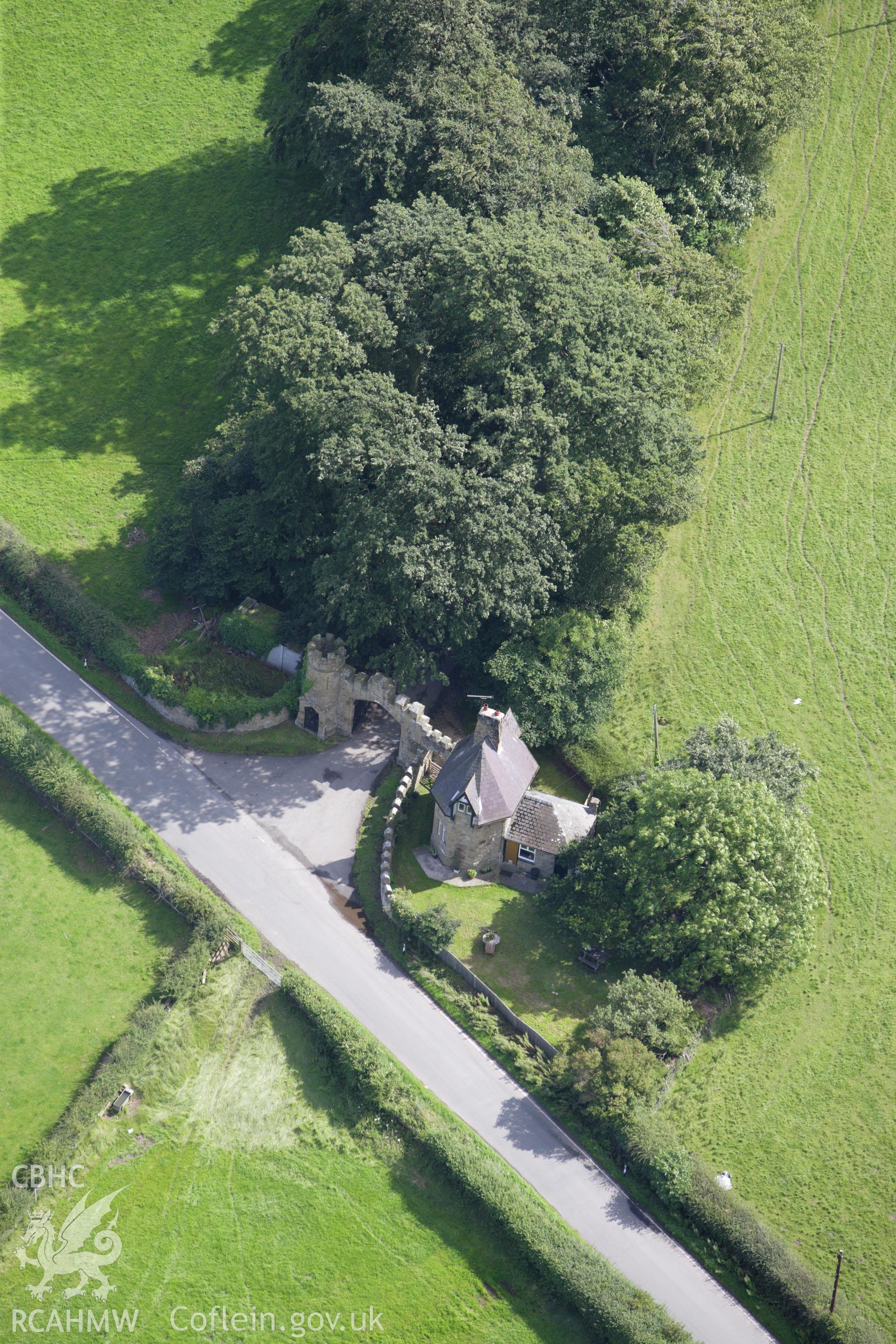 RCAHMW colour oblique aerial photograph of Gyrn Castle Lodge, Gates and Gateway. Taken on 30 July 2009 by Toby Driver