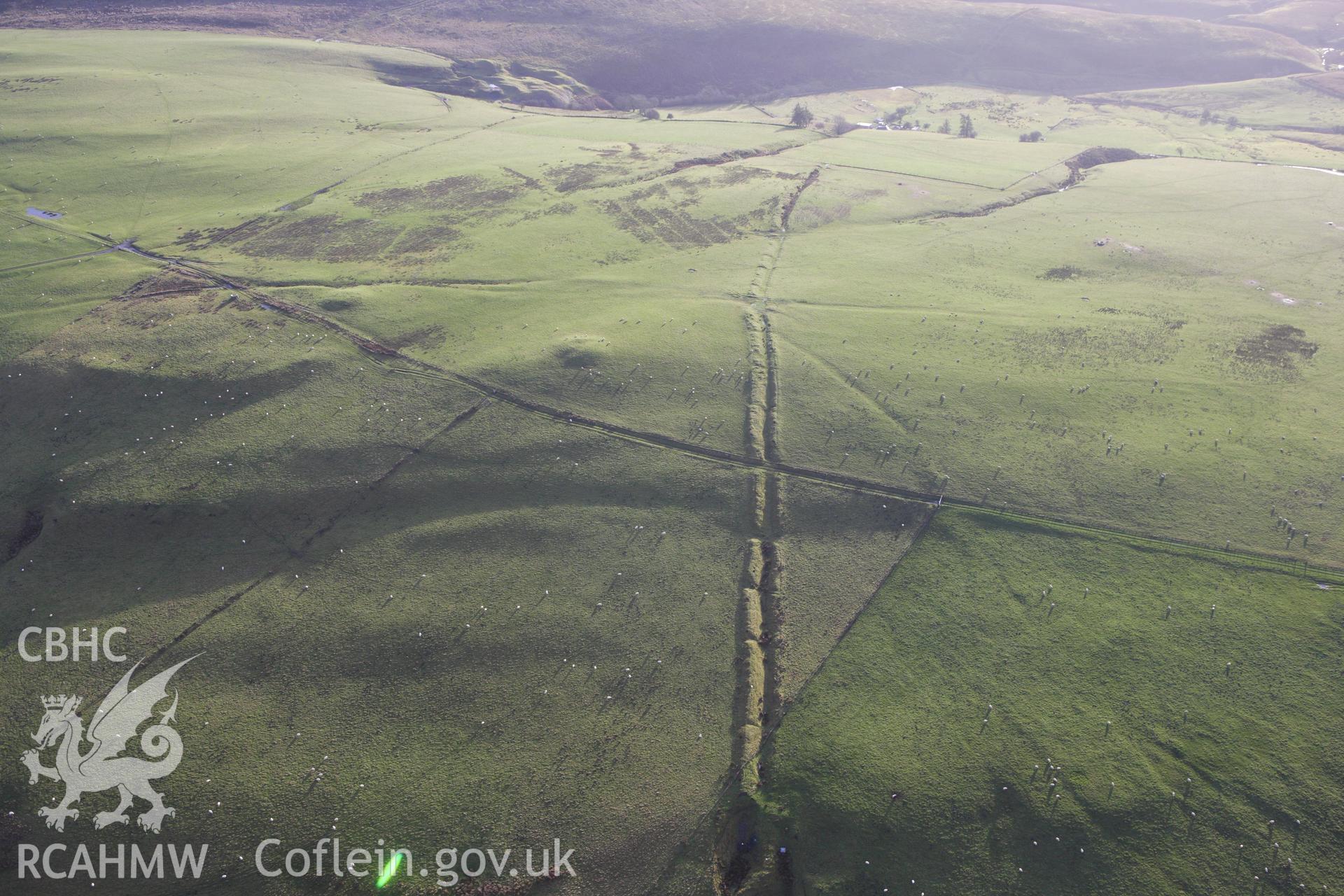 RCAHMW colour oblique aerial photograph of Two Tumps Dyke II and nearby barrows. Taken on 10 December 2009 by Toby Driver