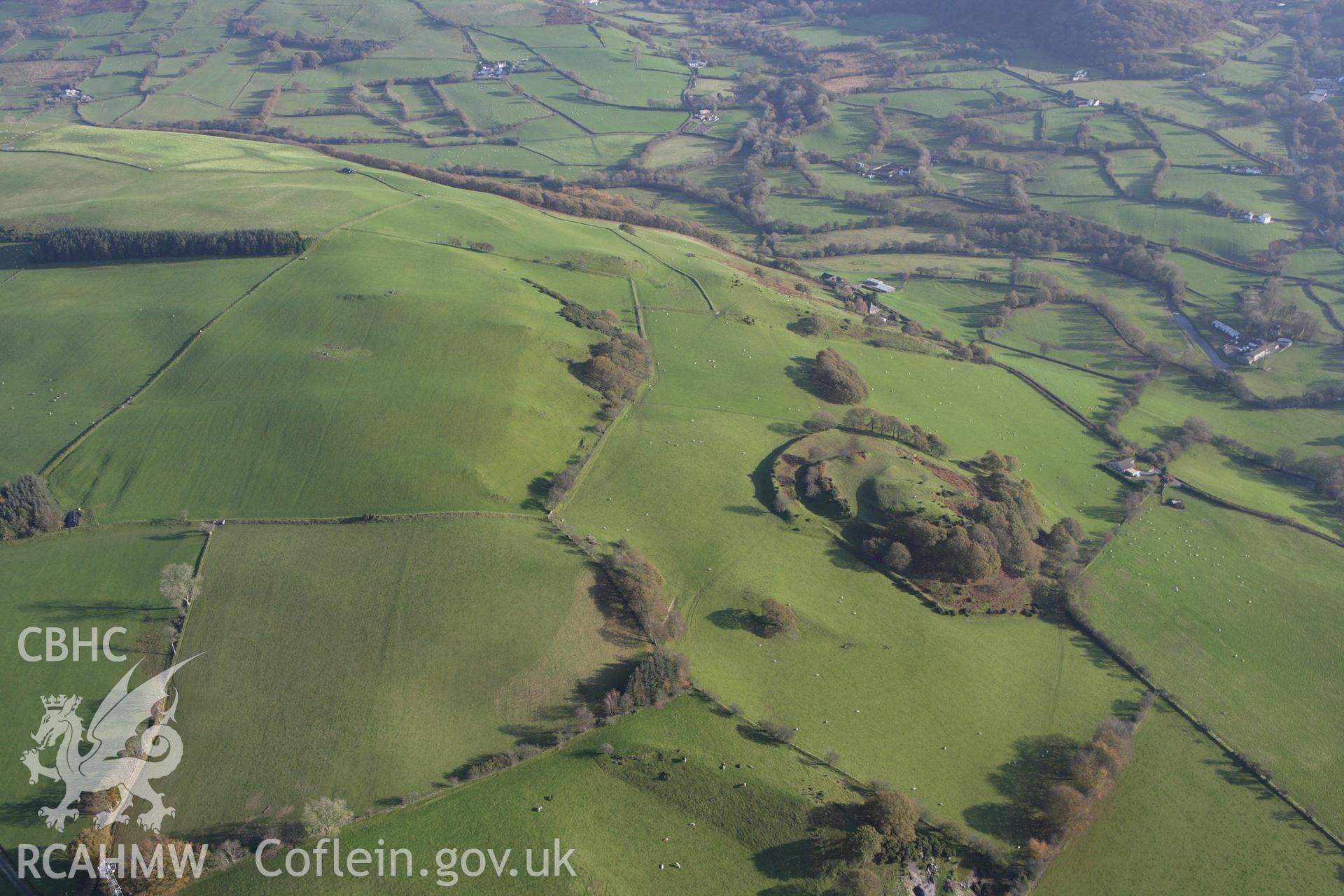 RCAHMW colour oblique aerial photograph of Castell Tregaron (Sunnyhill Wood Camp). Taken on 09 November 2009 by Toby Driver