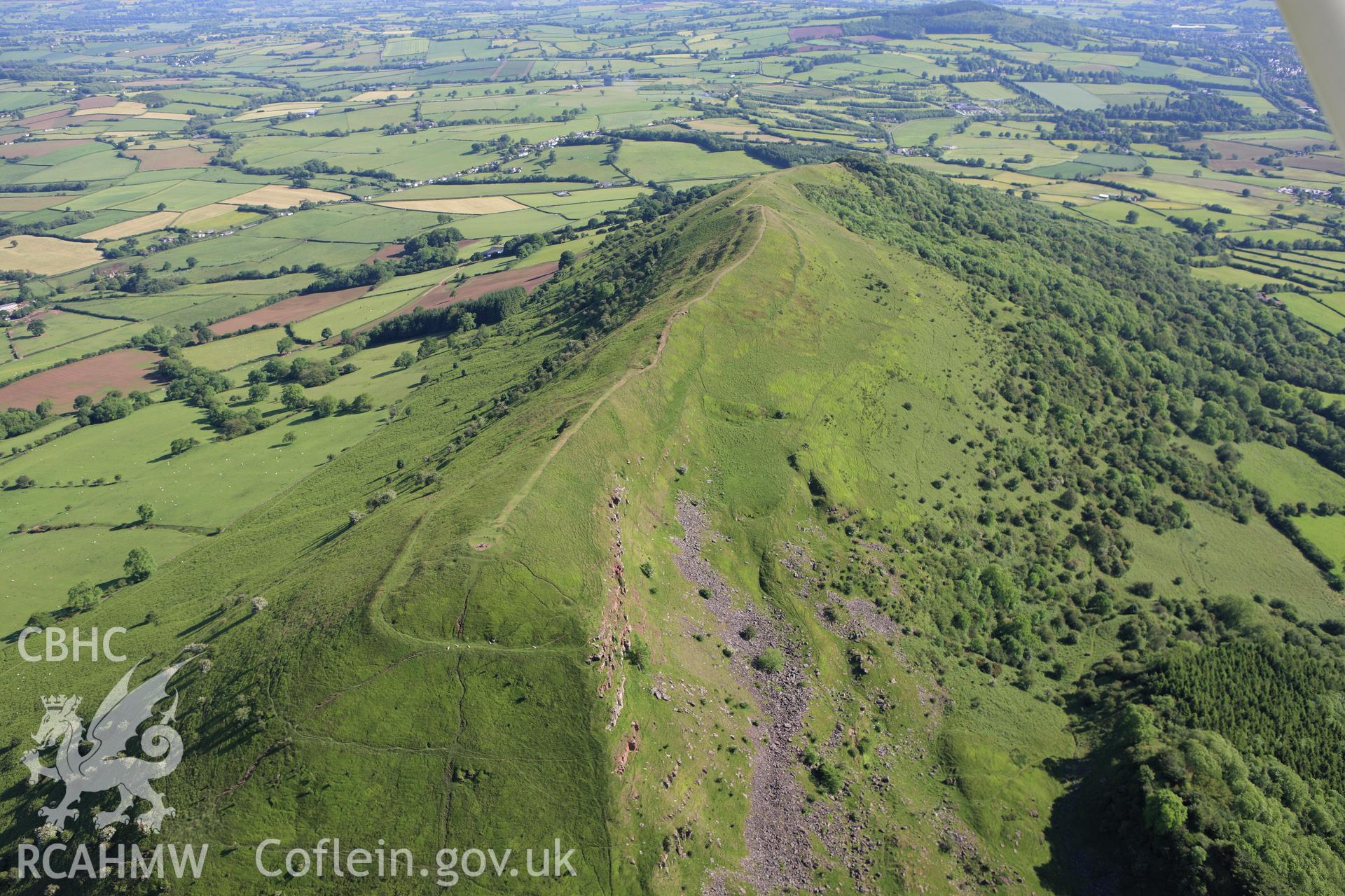 RCAHMW colour oblique aerial photograph of Skirrid Fawr Summit Enclosure. Taken on 11 June 2009 by Toby Driver