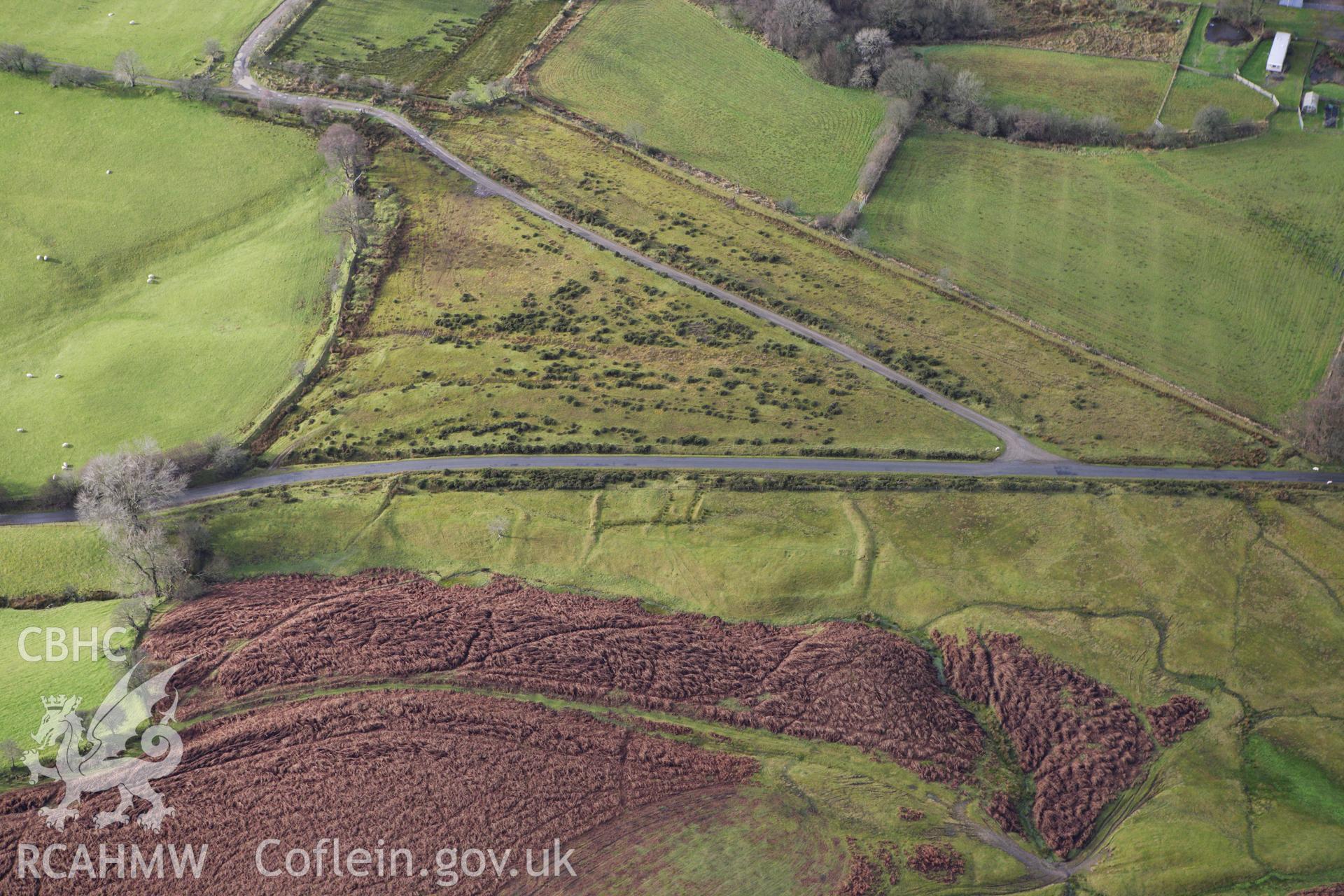RCAHMW colour oblique aerial photograph of an earthwork enclosure to the south of the Moelfre Hill Deserted Rural Settlement. Taken on 10 December 2009 by Toby Driver