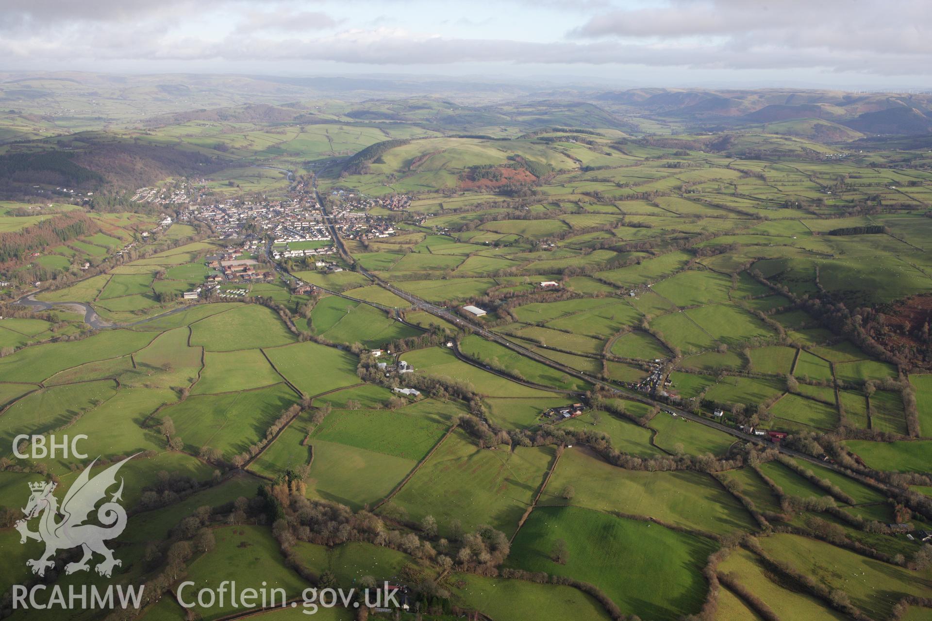 RCAHMW colour oblique aerial photograph of Llanidloes, in wide landscape view from the west. Taken on 10 December 2009 by Toby Driver