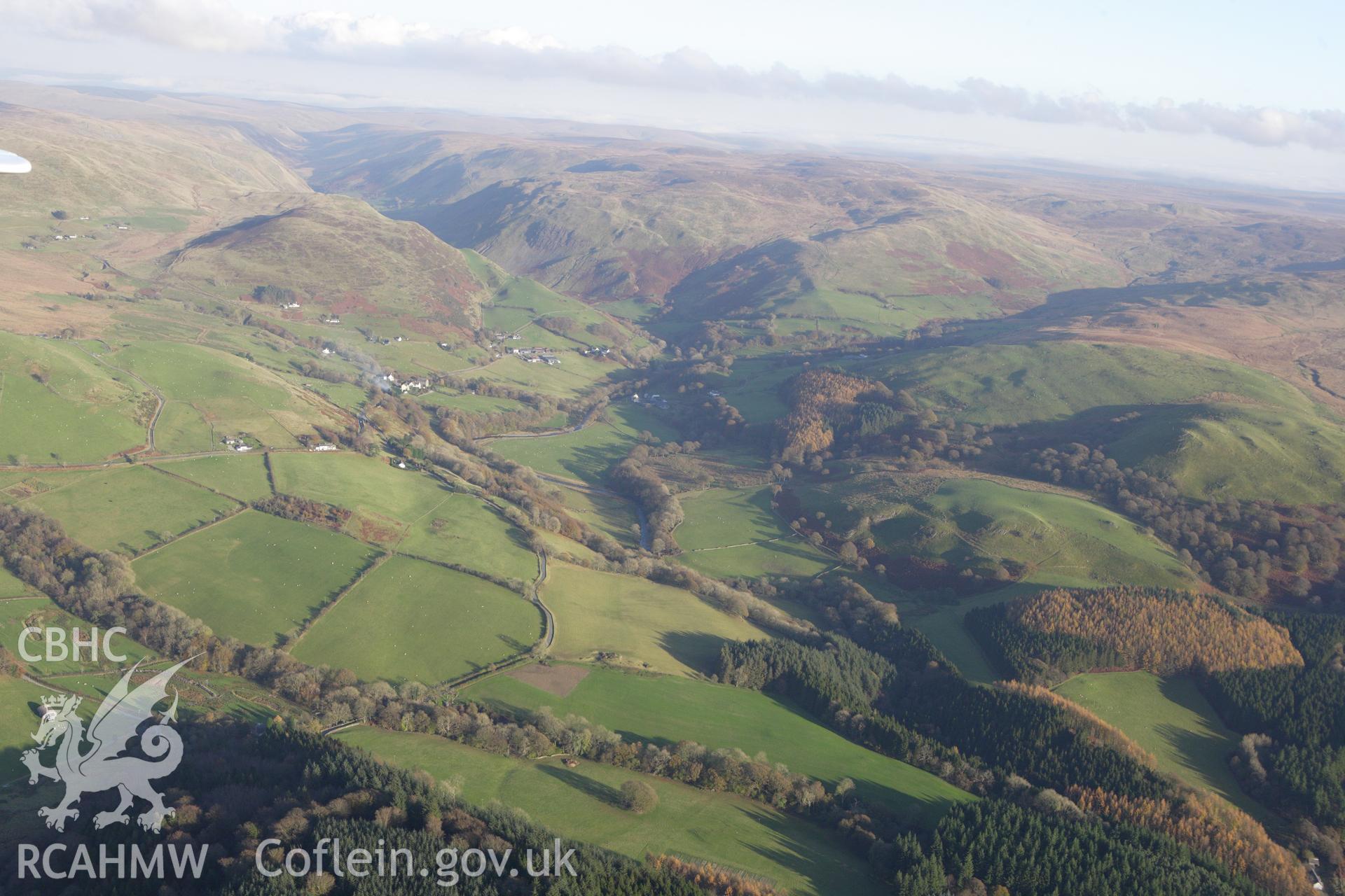 RCAHMW colour oblique aerial photograph of Cwmystwyth Village and the landscape to the west. Taken on 09 November 2009 by Toby Driver