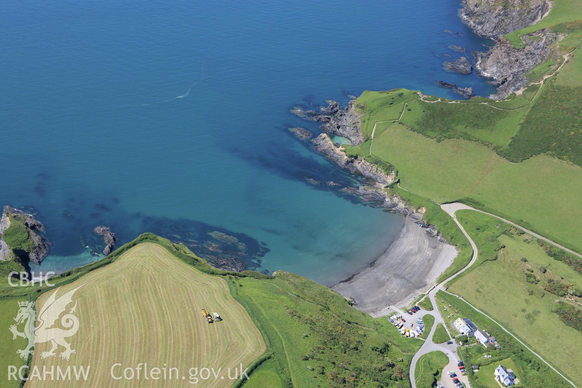 RCAHMW colour oblique aerial photograph of Pen Castell, Dinas Island showing Pwllgwaelod beach. Taken on 01 June 2009 by Toby Driver