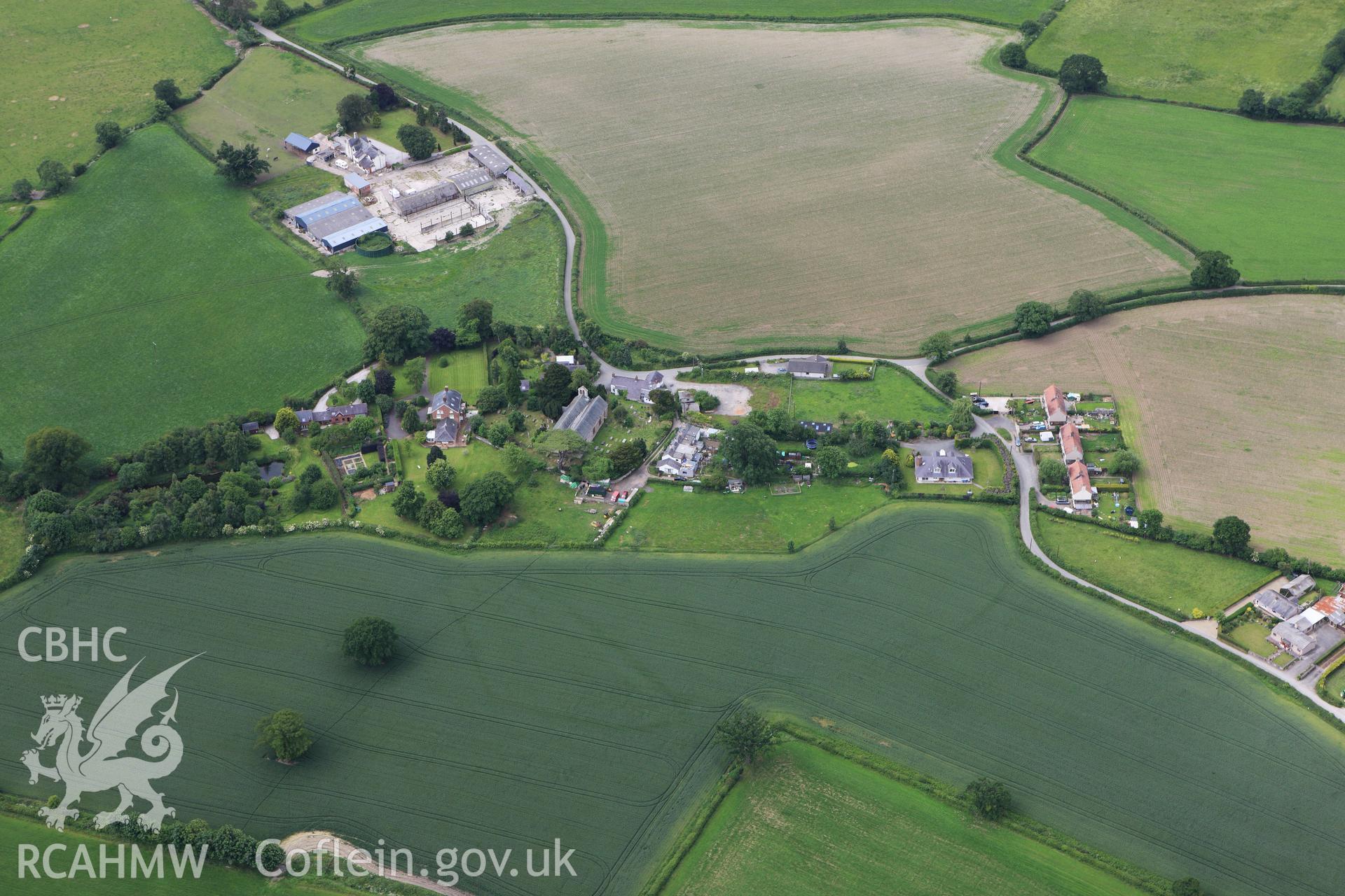 RCAHMW colour oblique photograph of St. Saeran's Church, Llanynys and cropmarks in adjacent fields. Taken by Toby Driver on 19/06/2009.