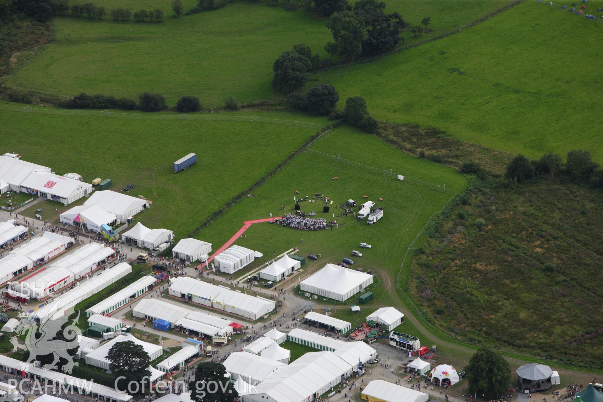 RCAHMW colour oblique aerial photograph of the site of the Eistedddfod at Bala in 1997 and 2009 showing the crowning ceremony. Taken on 06 August 2009 by Toby Driver