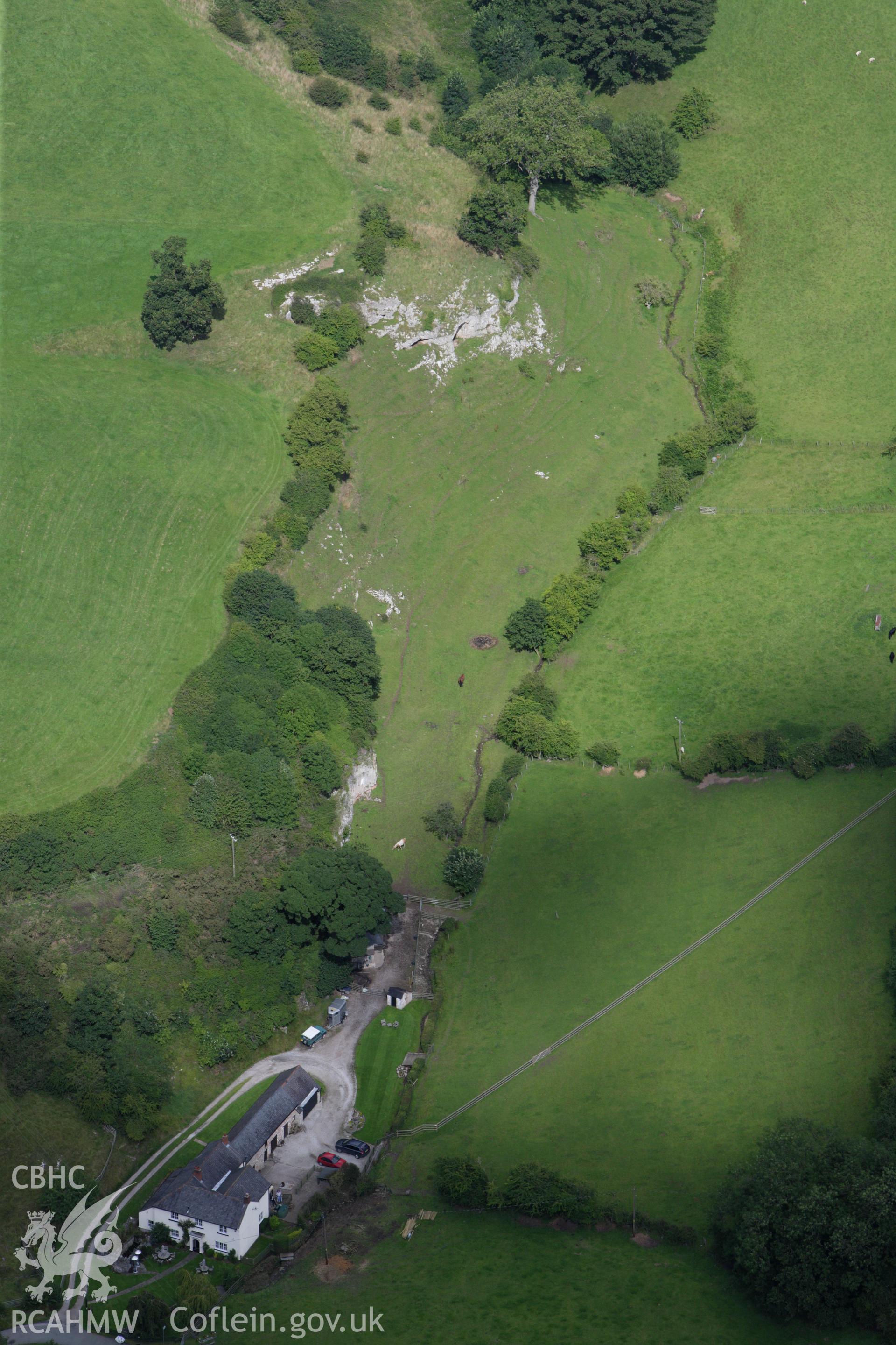 RCAHMW colour oblique aerial photograph of Ffynnon Beuno Cave. Taken on 30 July 2009 by Toby Driver