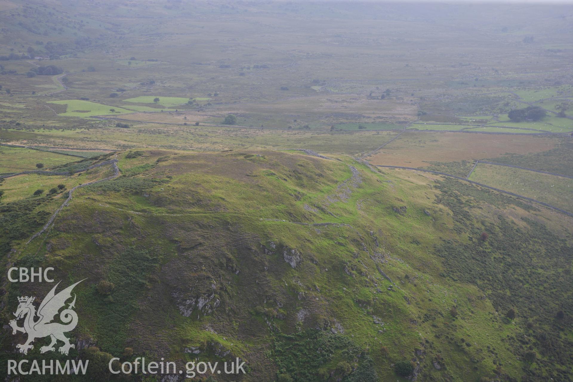 RCAHMW colour oblique aerial photograph of Pen-y-Gaer Hillfort. Taken on 06 August 2009 by Toby Driver