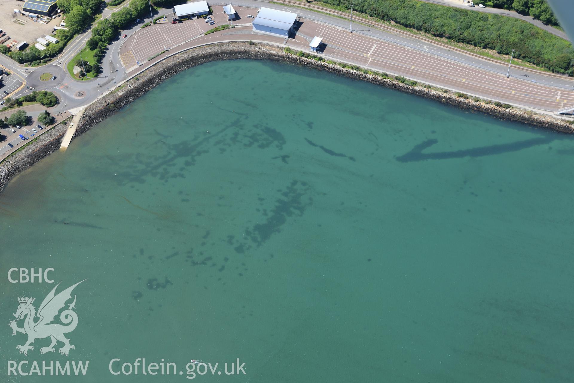 RCAHMW colour oblique aerial photograph of Fishguard Harbour North-West Fish Trap. Taken on 01 June 2009 by Toby Driver