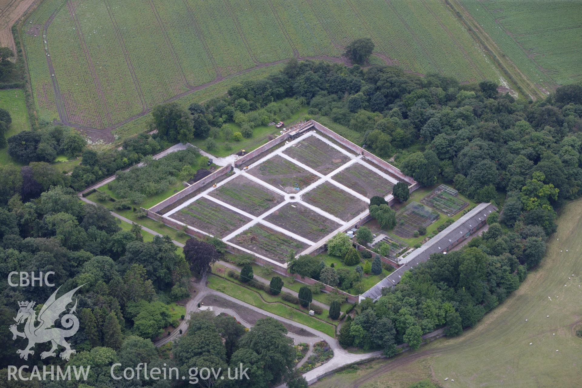 RCAHMW colour oblique aerial photograph of Mostyn Hall Main Block showing walled garden. Taken on 30 July 2009 by Toby Driver