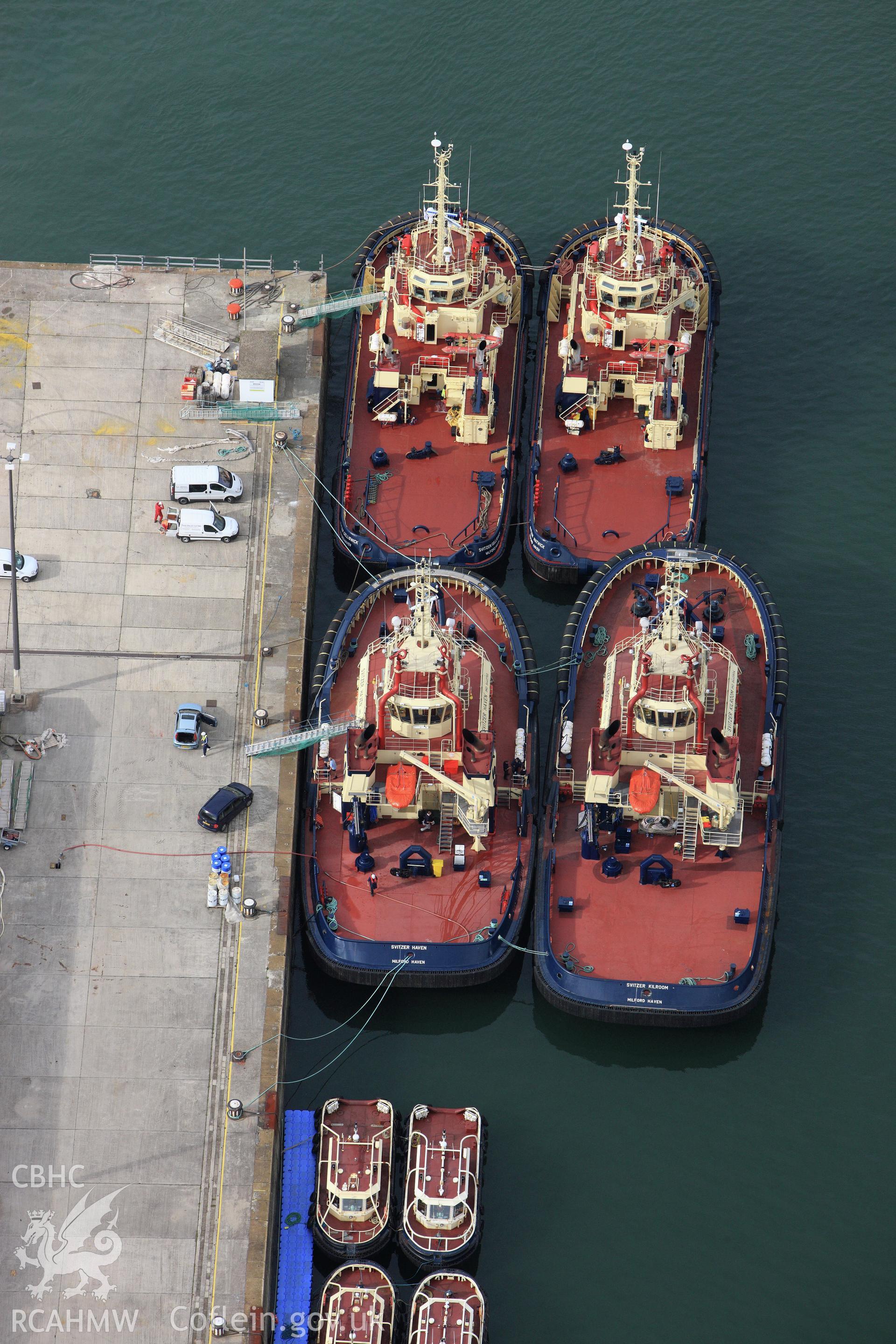 RCAHMW colour oblique aerial photograph of The Royal Dockyard at Pembroke Dock showing Port Authority tugs. Taken on 14 October 2009 by Toby Driver