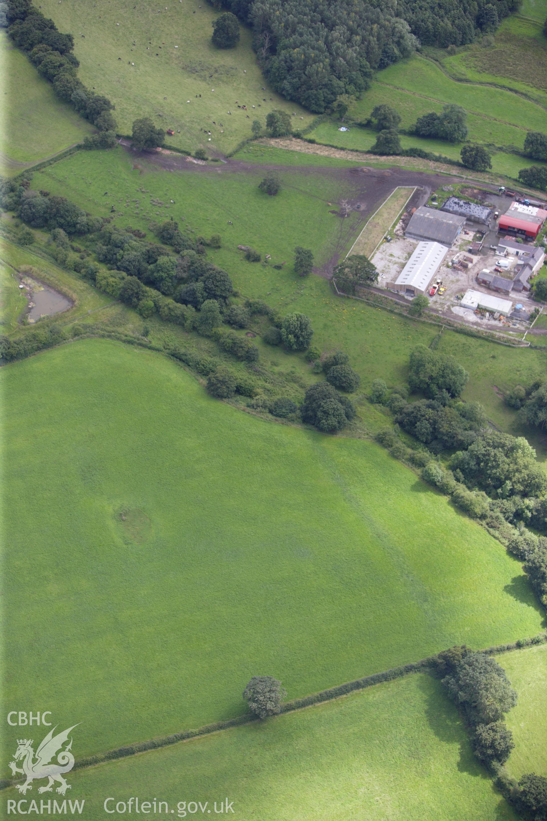 RCAHMW colour oblique aerial photograph of Wat's Dyke east of Padeswood, showing as a cropmark in a ploughed area. Taken on 30 July 2009 by Toby Driver