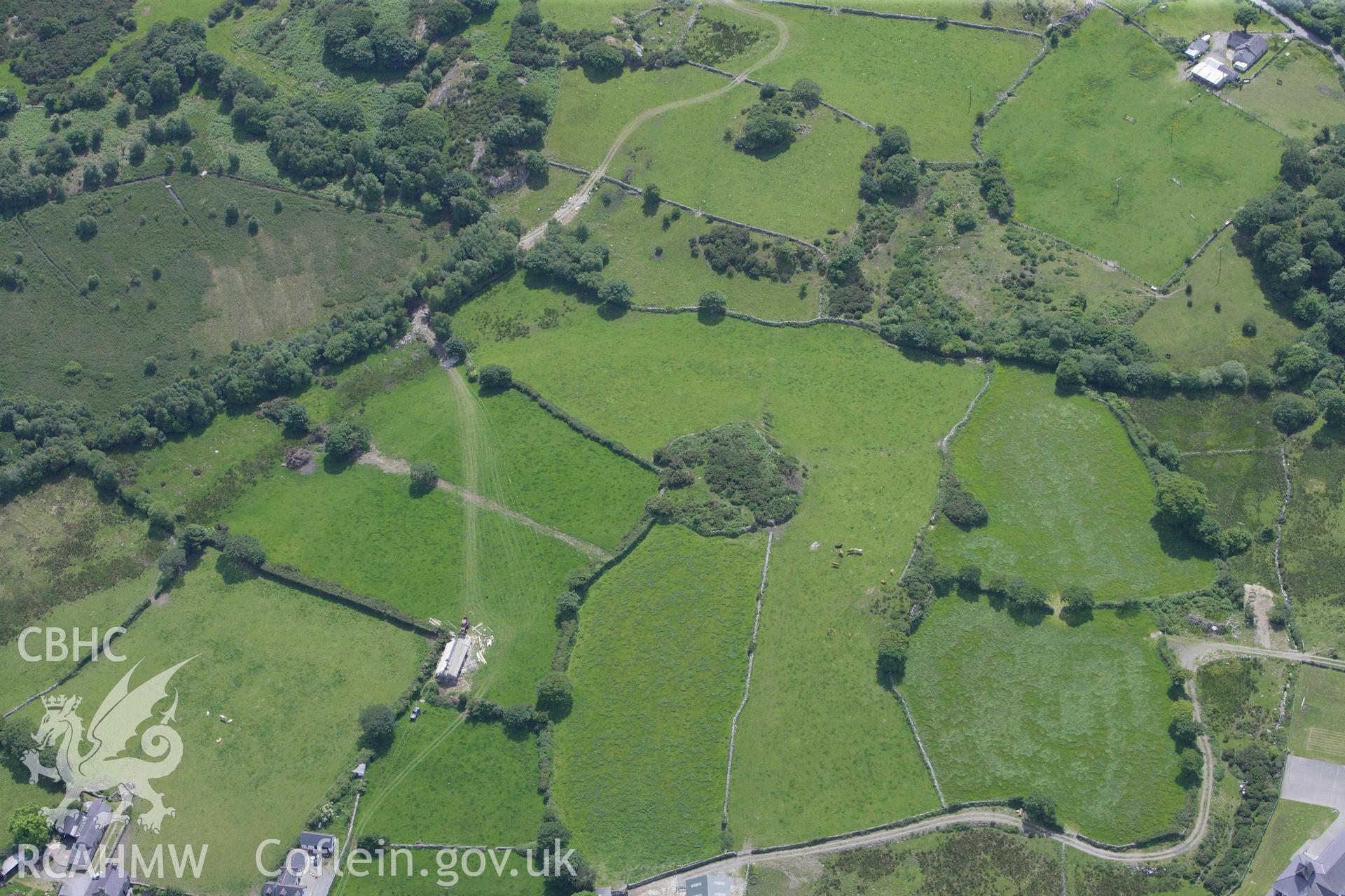 RCAHMW colour oblique aerial photograph of Pen-Isa'r-Waen Enclosed Hut Camp near Cae Corniog. Taken on 16 June 2009 by Toby Driver