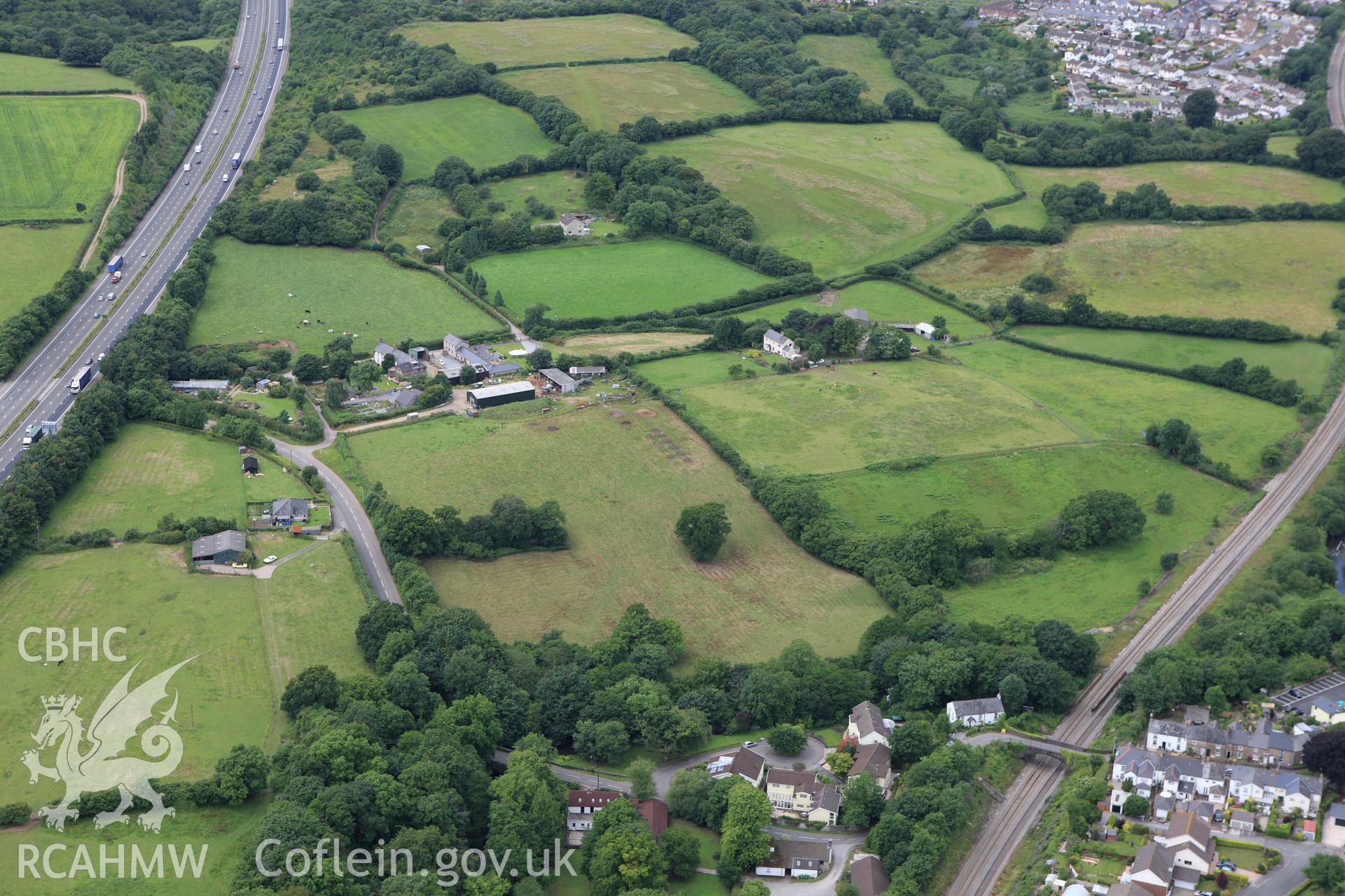 RCAHMW colour oblique aerial photograph of Miskin Roman Fort. Taken on 09 July 2009 by Toby Driver