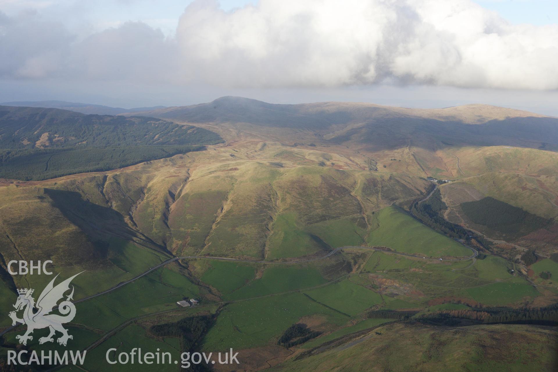 RCAHMW colour oblique aerial photograph of Esgair Lle Lead Mine, Eisteddfa Gurig, and the surrounding landscape from the south-west. Taken on 09 November 2009 by Toby Driver