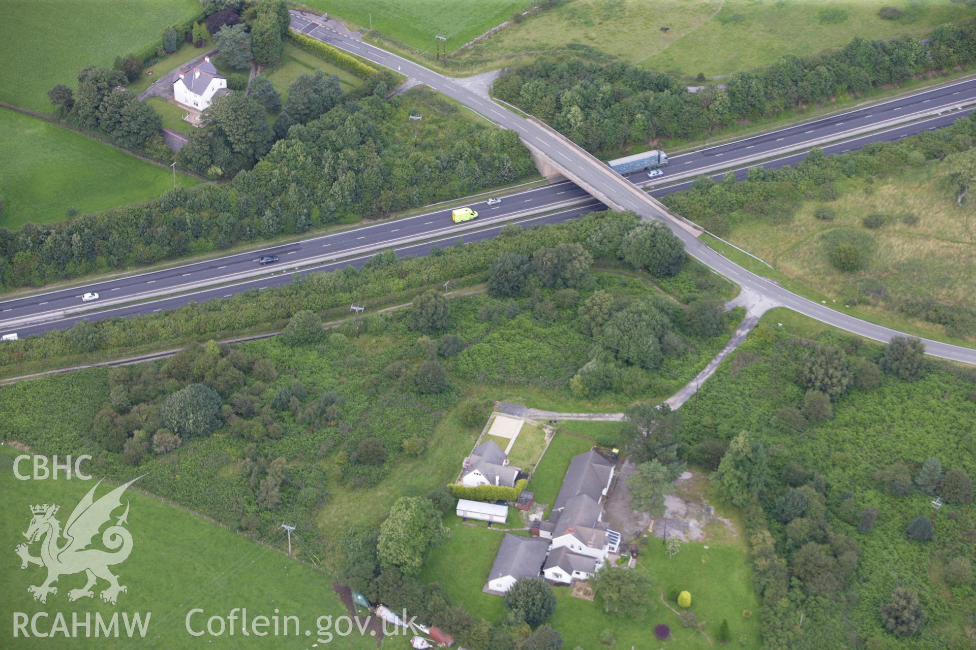 RCAHMW colour oblique aerial photograph of Naid-y-March Round Barrow. Taken on 30 July 2009 by Toby Driver