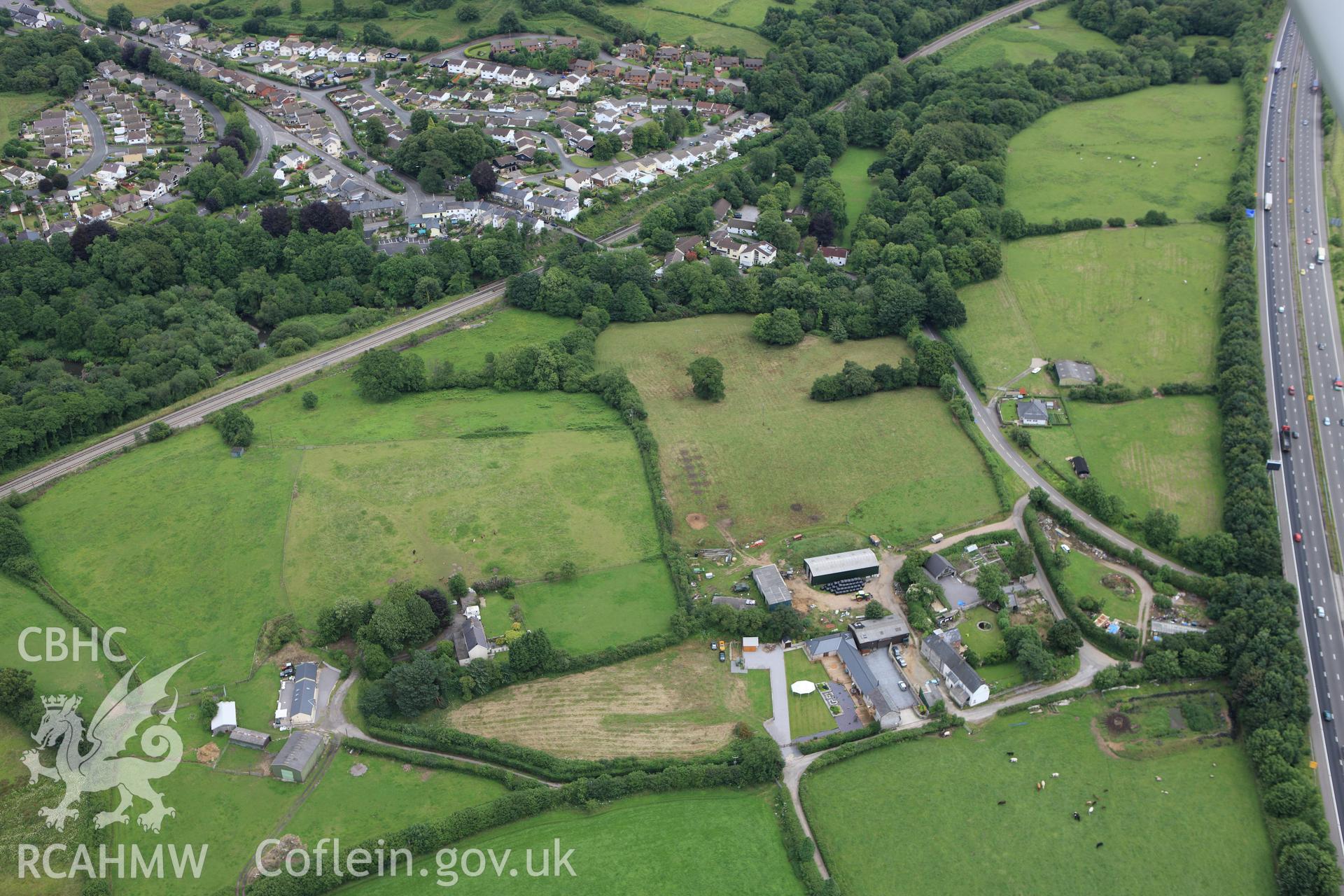 RCAHMW colour oblique aerial photograph of Miskin Roman Fort. Taken on 09 July 2009 by Toby Driver