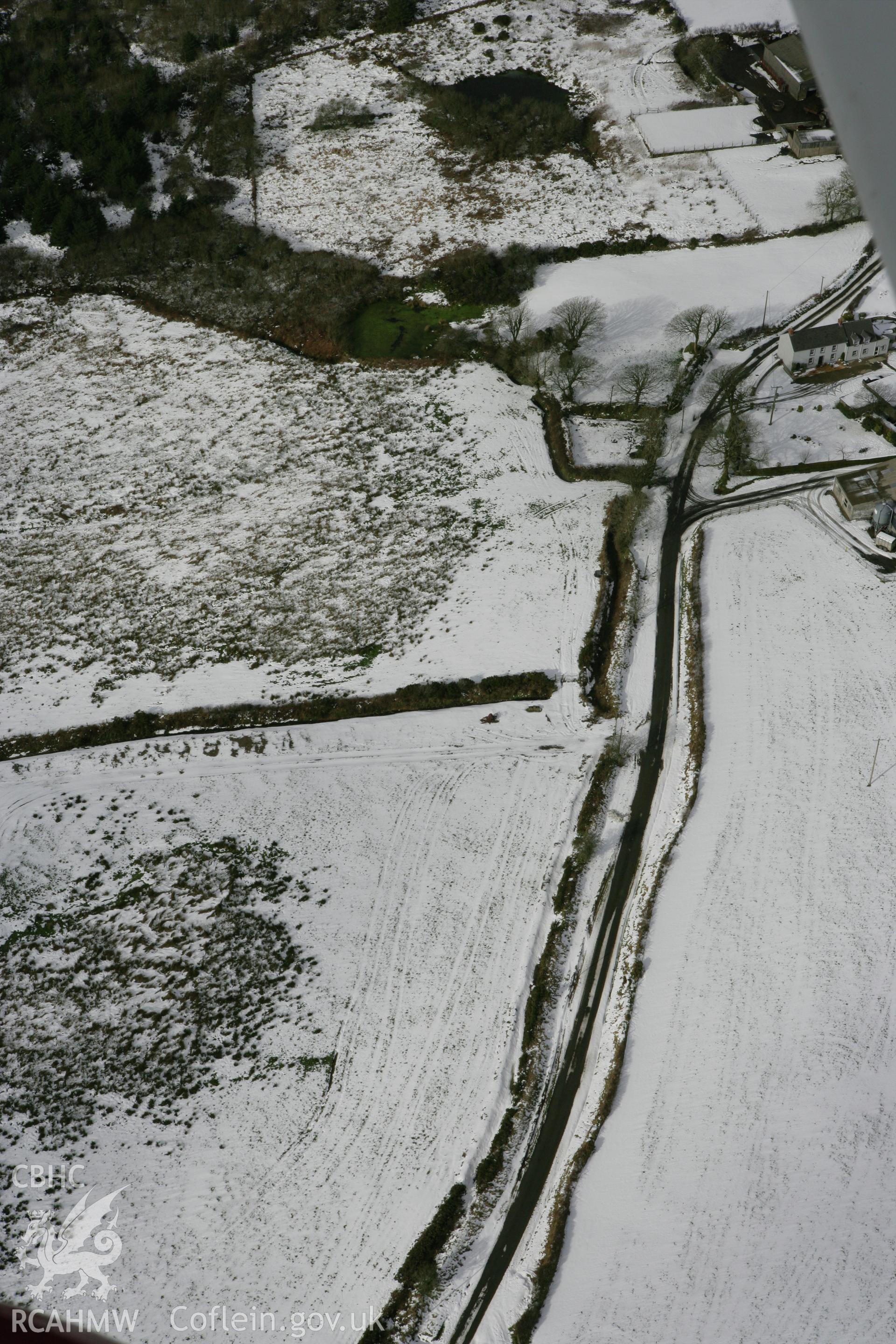 RCAHMW colour oblique photograph of Marsh cottage round barrow. Taken by Toby Driver on 06/02/2009.