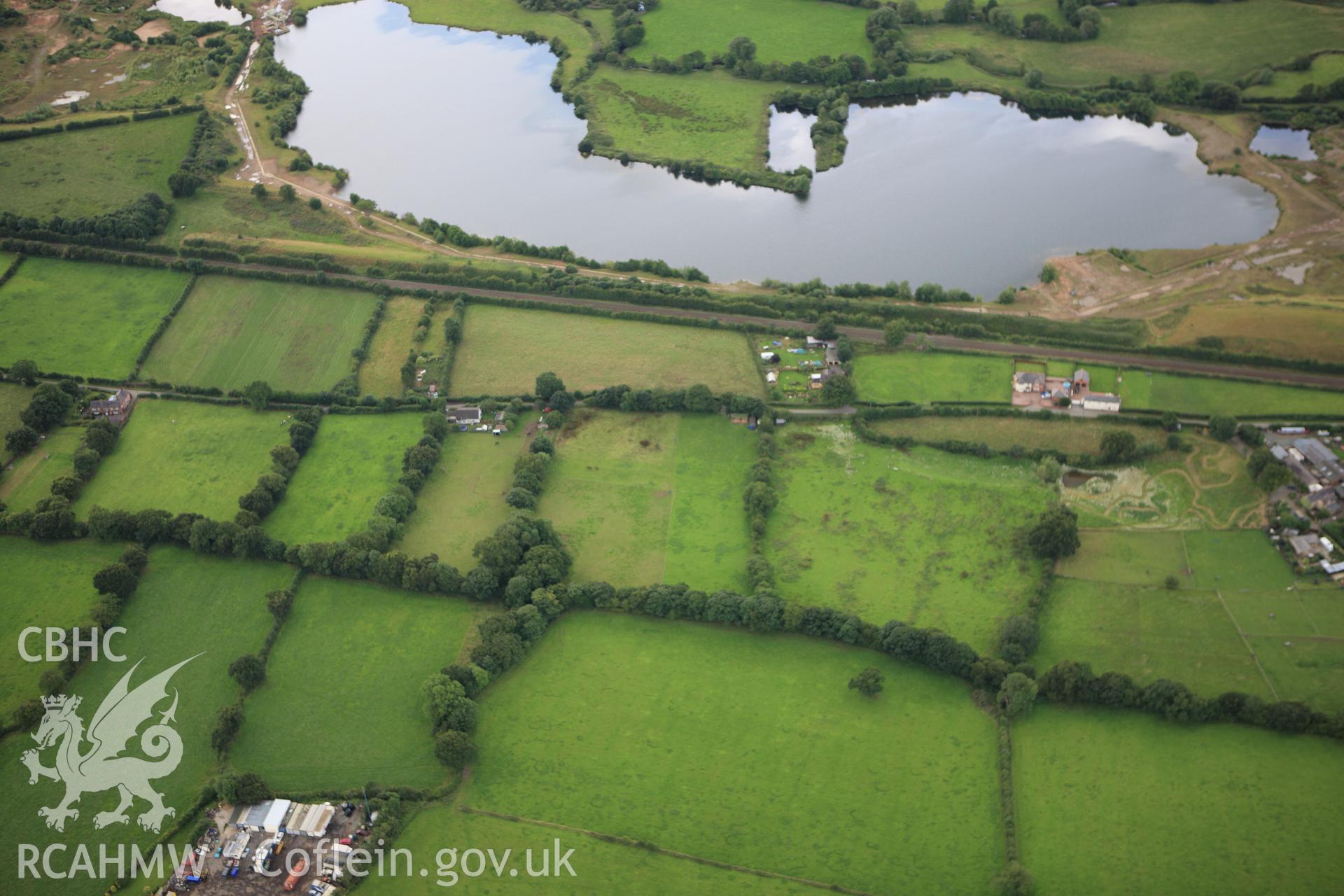 RCAHMW colour oblique aerial photograph of two sections of Wat's Dyke between Clawdd Offa and Pigeon House Farm. Taken on 30 July 2009 by Toby Driver